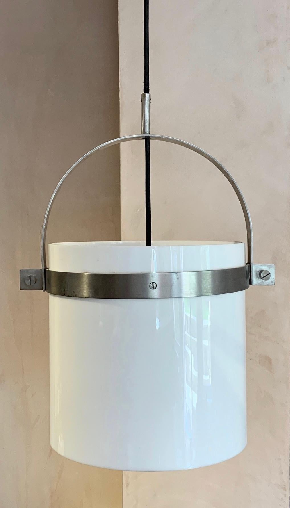 A cool looking brushed steel and perspex ceiling light, pendant by the Spanish Designer Jordi Vilanova Bosch (1925-1998). Good stylish brushed steel detail. Great light for a hall way and above a dining table. Can be used with a dimmer. Timeless
