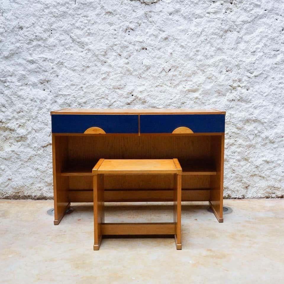 Set of desk and stool designed by Jordi Vilanova, circa 1960.

In original condition, with some visible signs of previous use and age, preserving a beautiful patina.

Materials:
Wood 

Dimensions:
Desk:
D 44 cm x W 111 cm x H 75