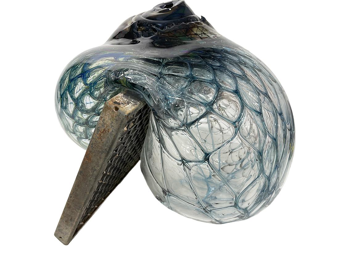 Jörg F. Zimmermann German, blown glass sculpture

Jörg Zimmermann (1940 -) is a German glass artist of organic blown glass sculptures. A Blown glass sculpture with wire mesh interior. This Shell shaped sculpture made of glassblowing and