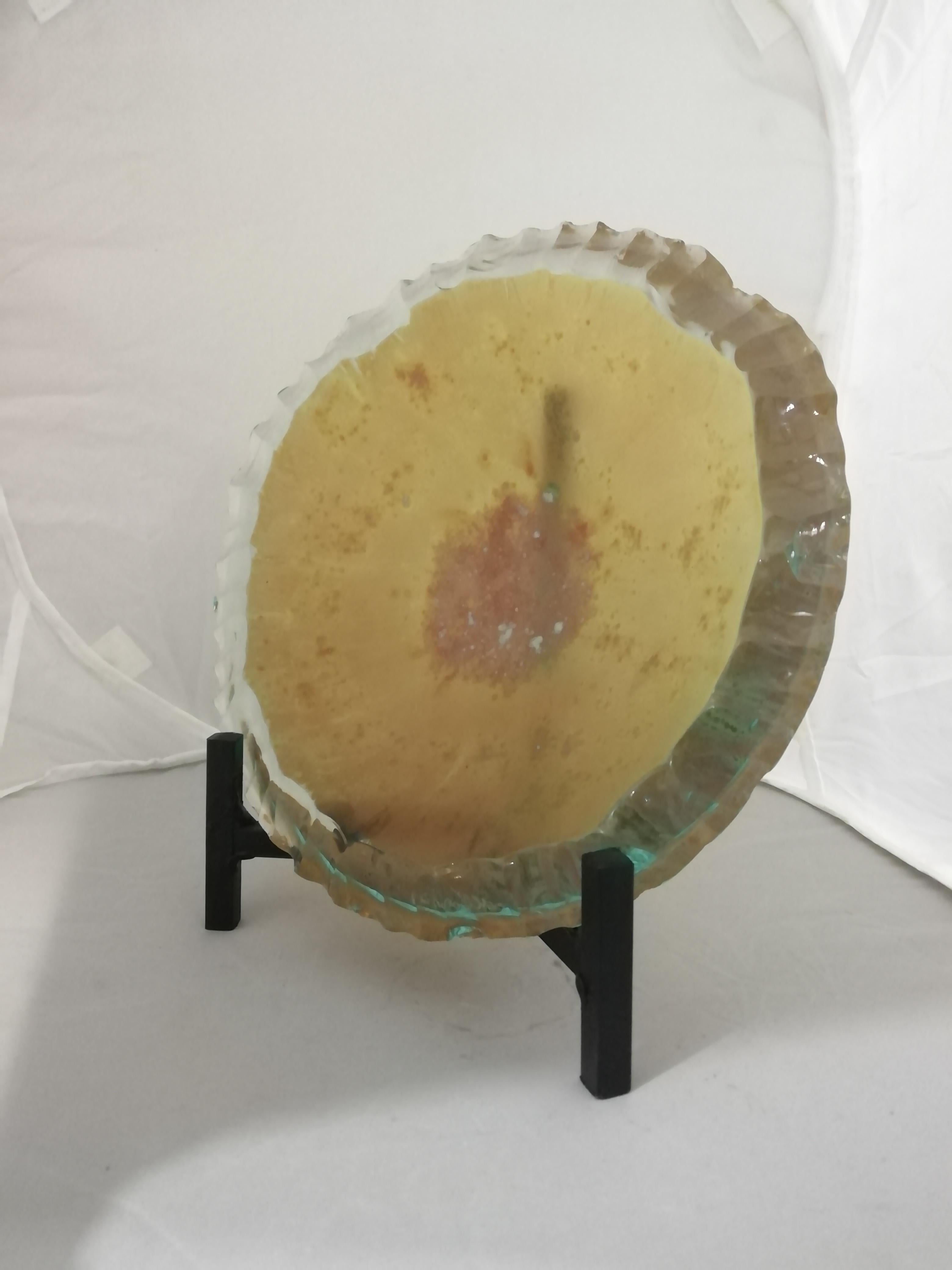 A pair of Mexican thick glass bowls by glassworker Jorge Ortiz Bencomo from Guadalajara, Jalisco.

The brutalist design features a chiseled irregular cut and yellow acid distressed center. Both plates are signed on the back. Plate holders are
