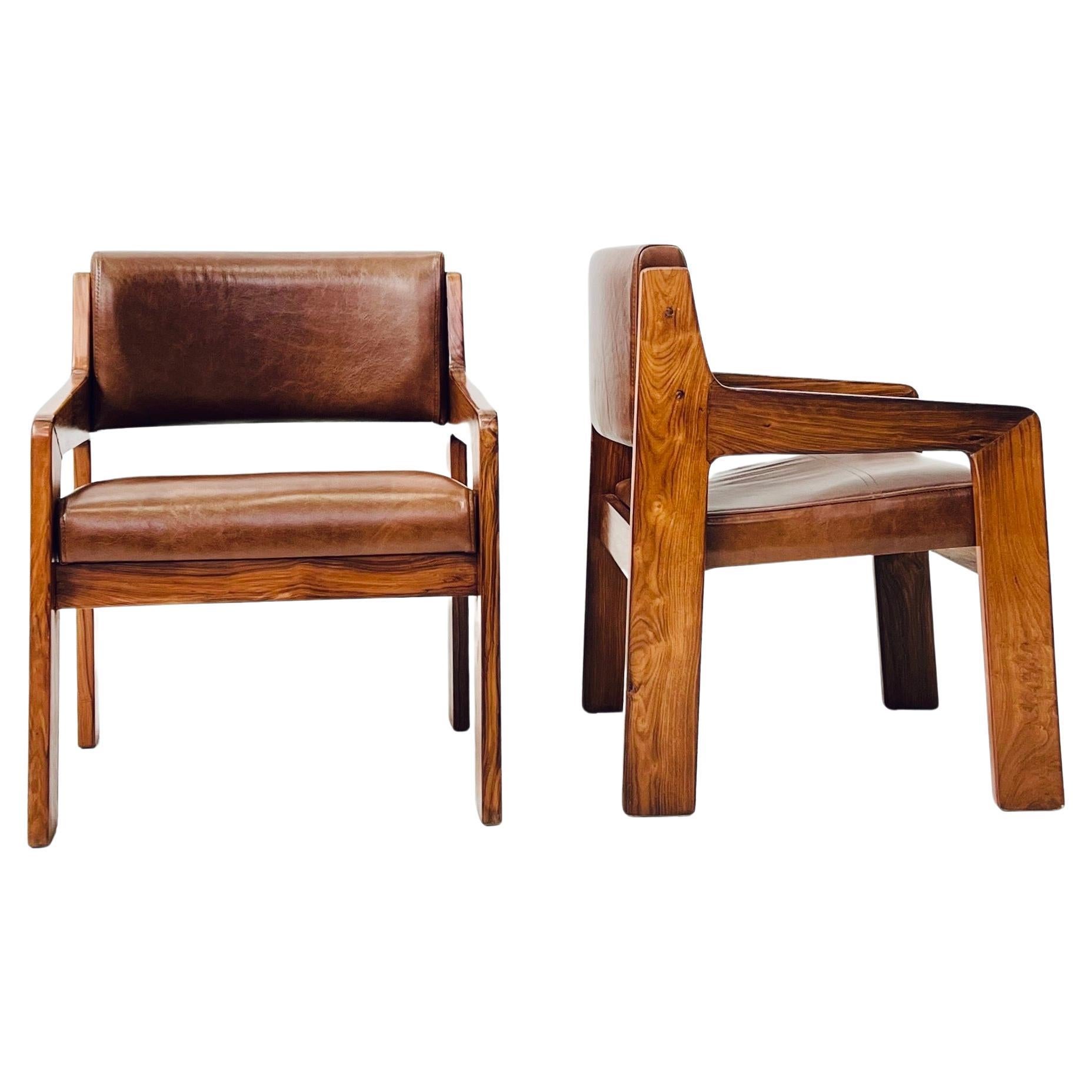 Pair of original armchairs designed by renowned Brazilian designer Jorge Zalszupin in Caviúna wood and natural leather seats. This pair made up the decoration of the 'Hotel Nacional do Rio de Janeiro', a project by architect Oscar Niemeyer in the