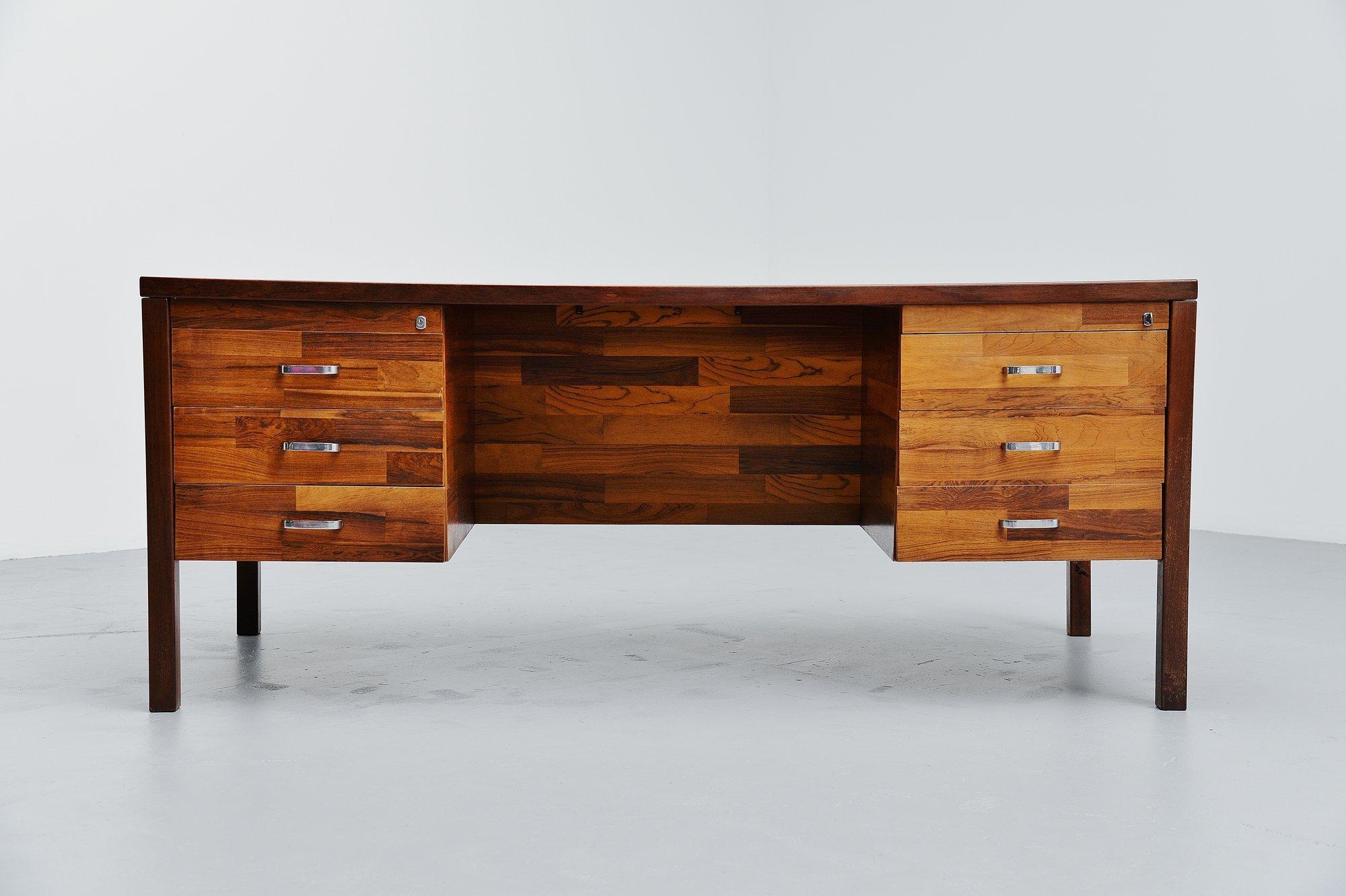 Beautiful rosewood patchwork desk attributed to Jorge Zalszupin, Brazil, 1960. This desk has a nice not to large size, but plenty of storage options because of the 2 large drawer cabinets on both sides. The desk top is a bit bent because of age, but