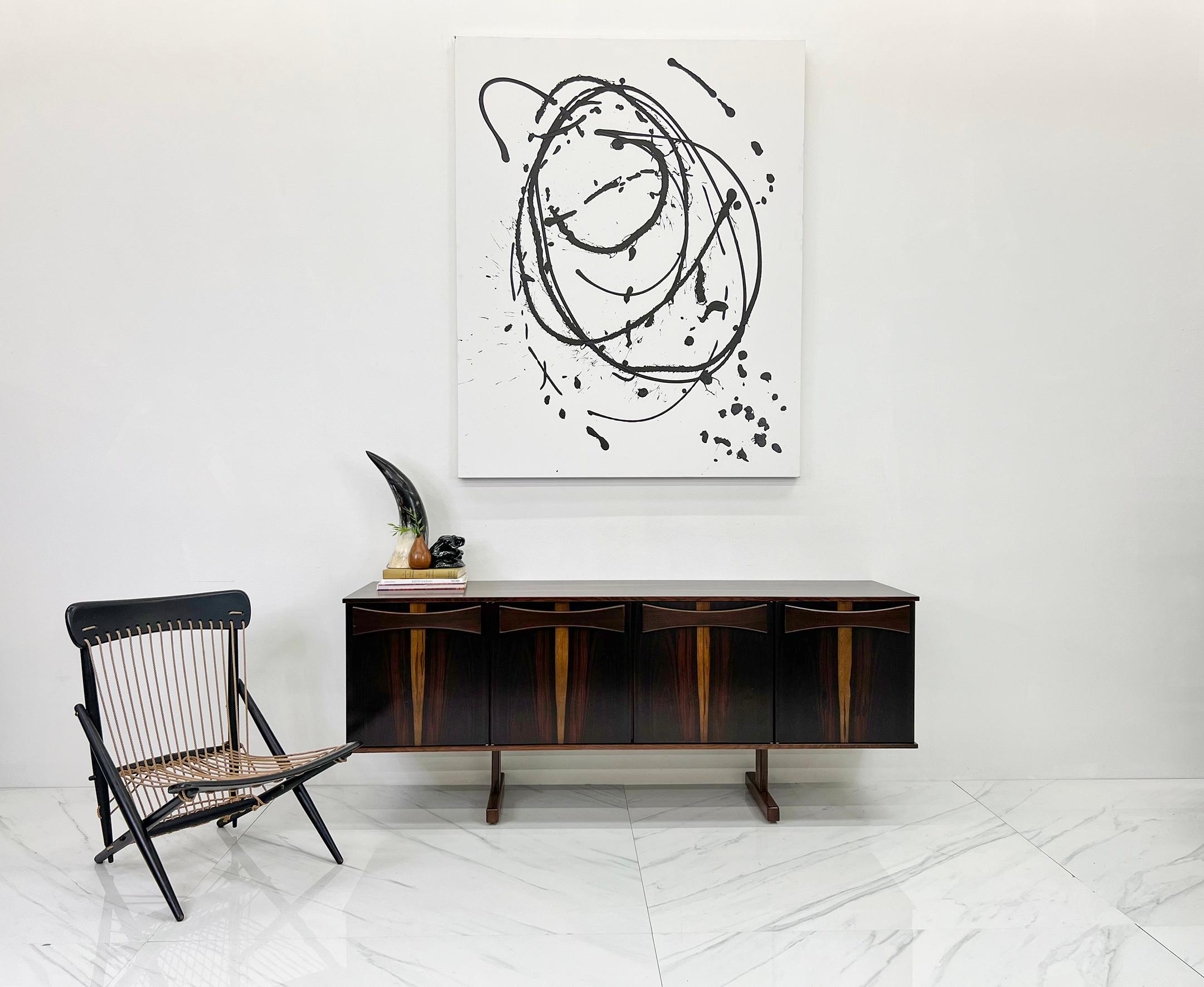 This piece is stunning! Designed by the renowned Brazilian furniture designer, Jorge Zalszupin for renowned Brazilian furniture manufacturer JD Móveis e Decorações, this credenza / sideboard demands attention. Crafted with meticulous attention to
