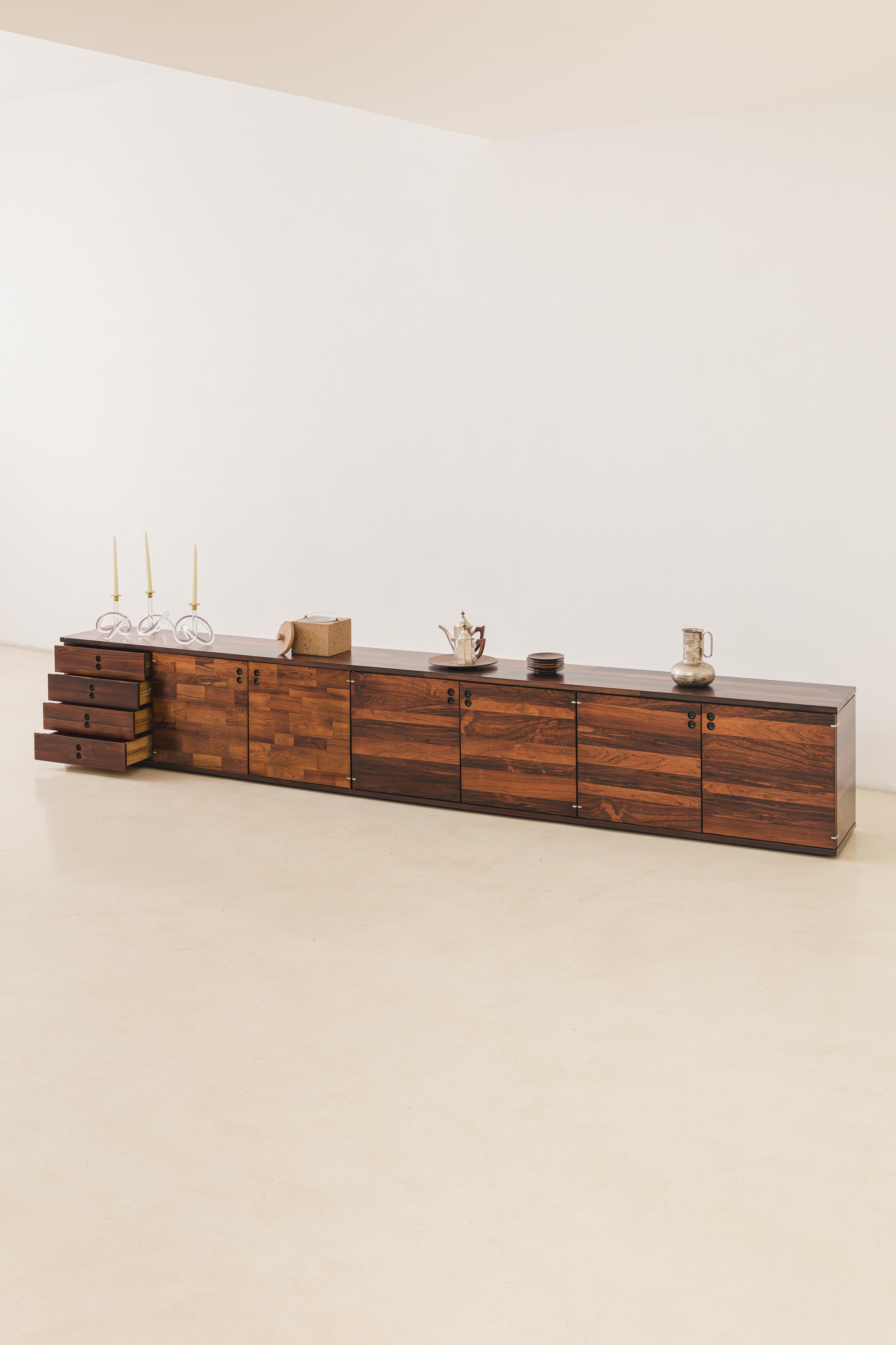 The modulated units were designed by Jorge Zalszupin (1922-2020) during the 1960s.

The piece remained in the designer's possession, for over four decades, in his personal residence. Entirely covered with rectangular pieces of marquetry wood, it is