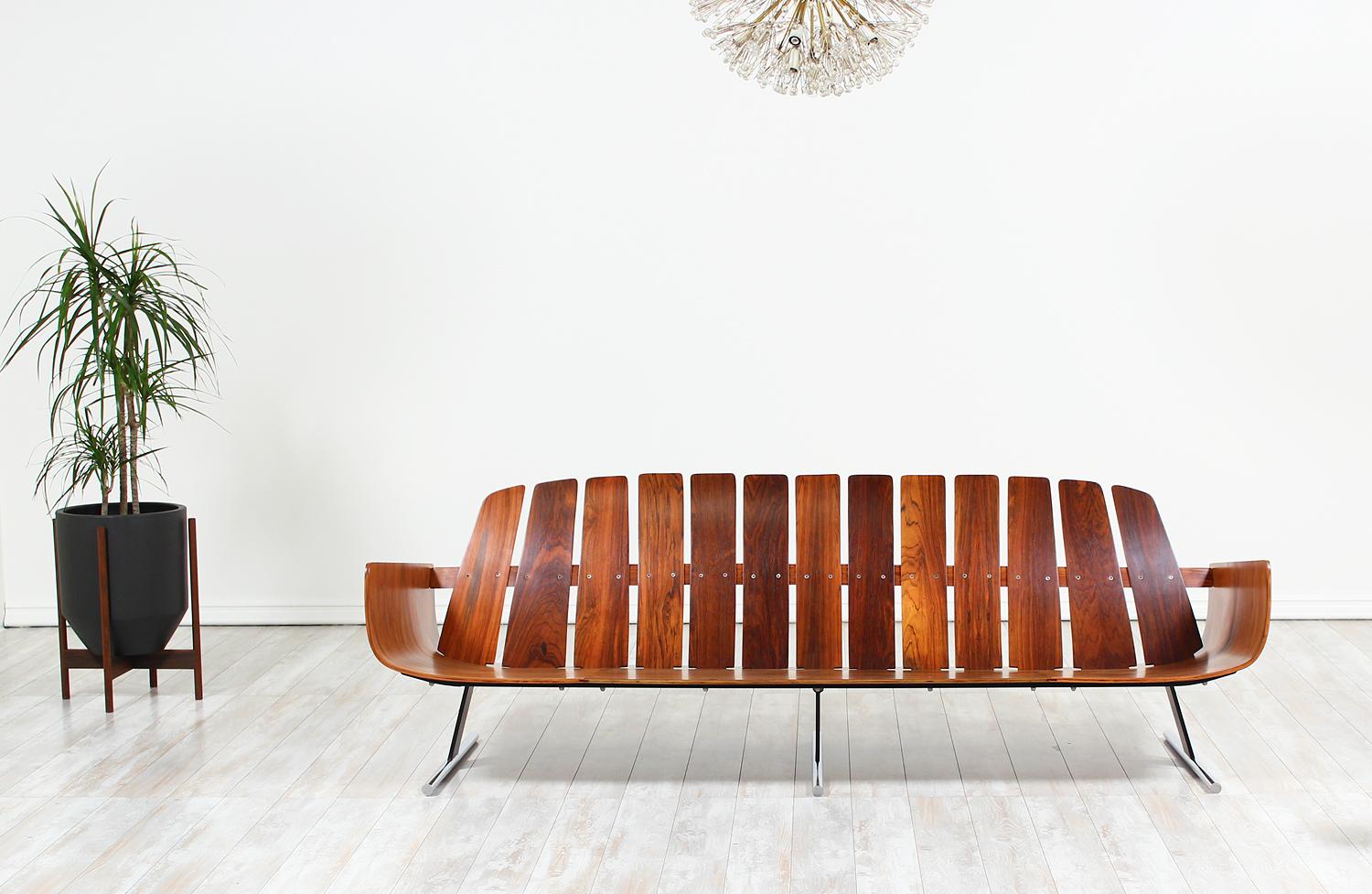 Iconic “Presidencial” sofa designed by Jorge Zalsupin for L’Atelier in Brazil circa 1960s. This rare and sophisticated sofa is comprised of a rosewood frame and enameled steel and chrome-plated steel sled legs. The incorporation of various materials