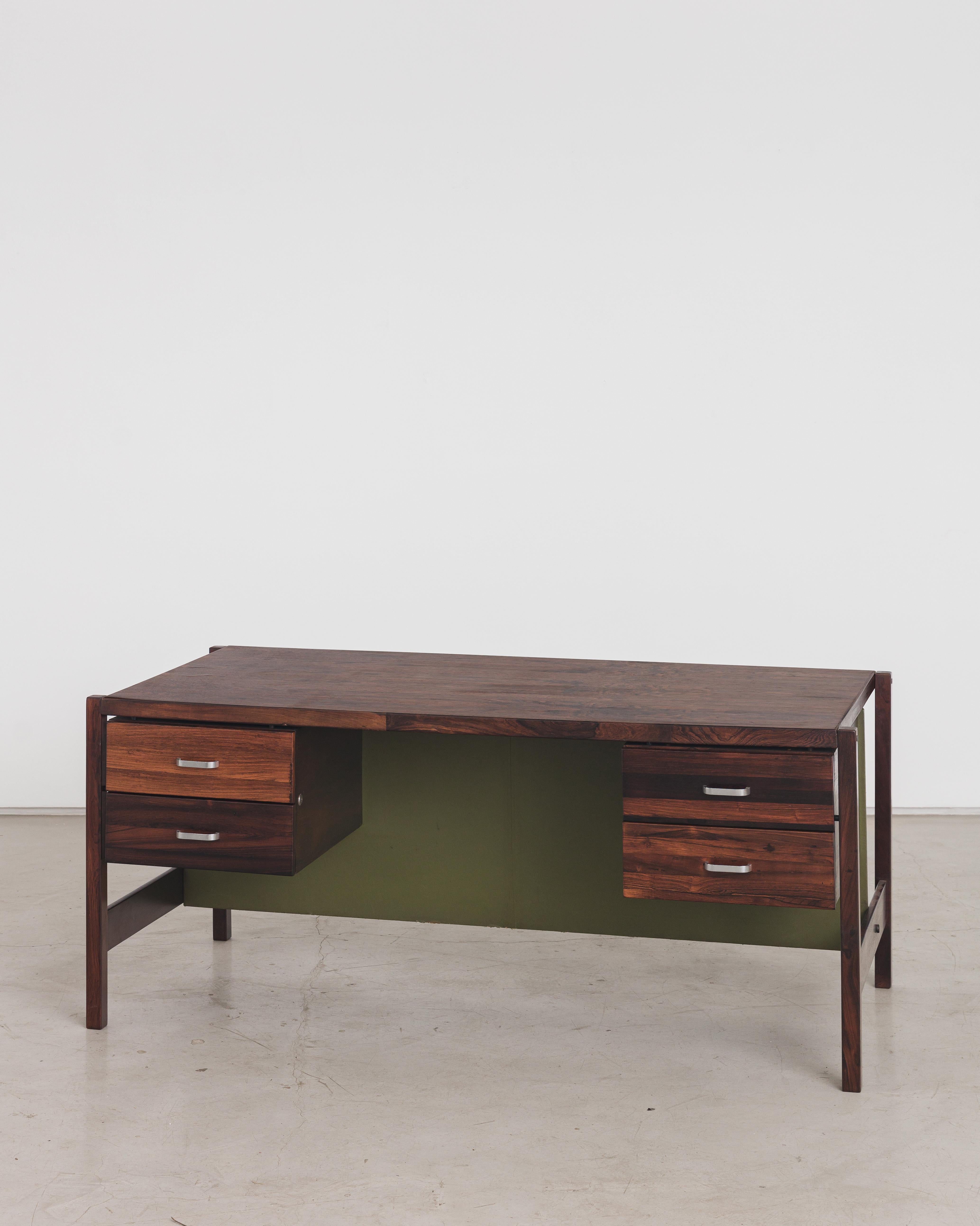 Writing desk designed by Jorge Zalszupin and manufactured by his company, L'Atelier. This piece has four drawers on each side. All the top is covered with rosewood veneer. The structure is in solid rosewood with green leather back details. The