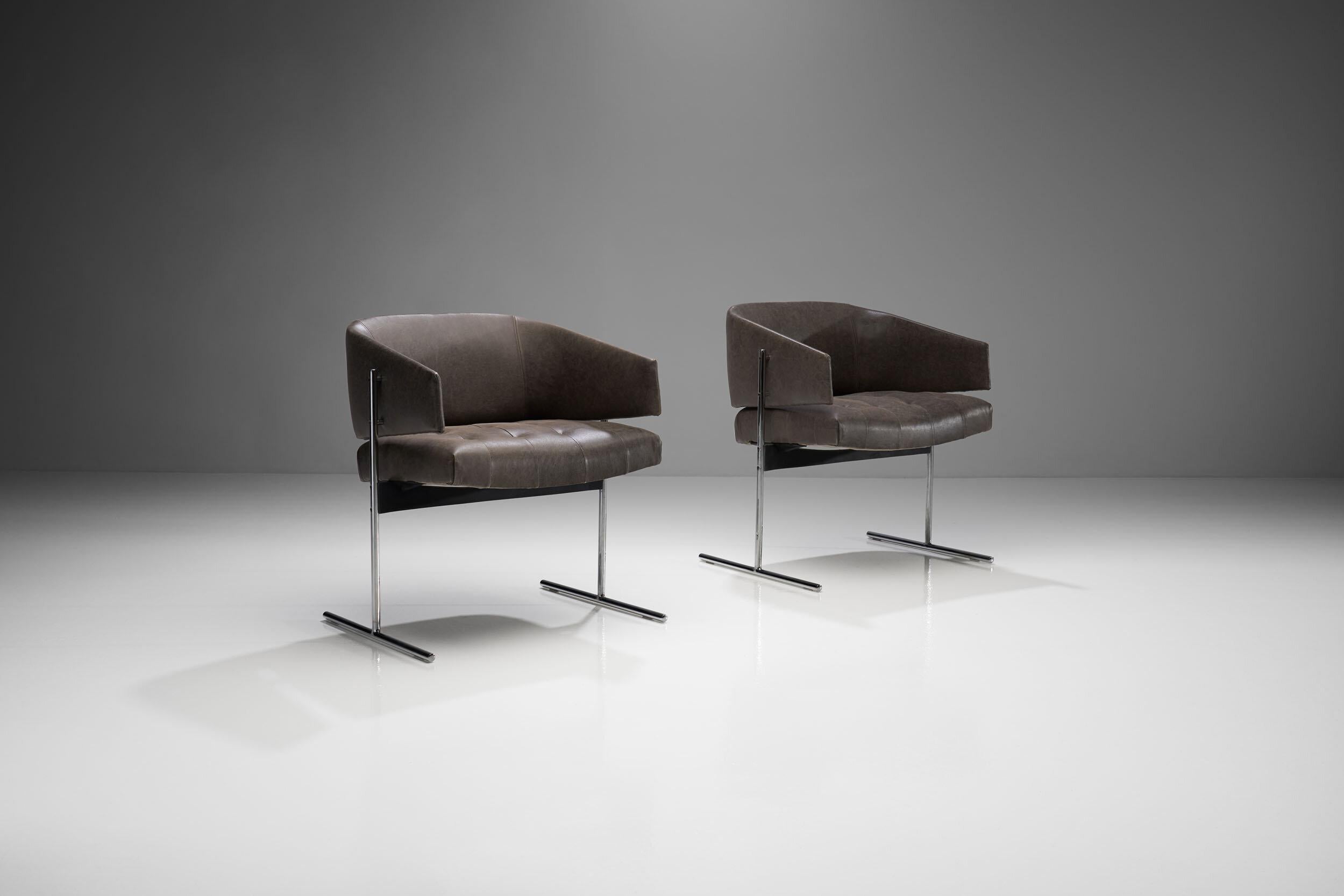 Designed between 1959-1969 by Jorge Zalszupin these 'Senior' chairs are simultaneously understated and elegant. The thin stainless steel legs that have been cleverly designed to carry all the weight, give the upholstered curved back and seat an