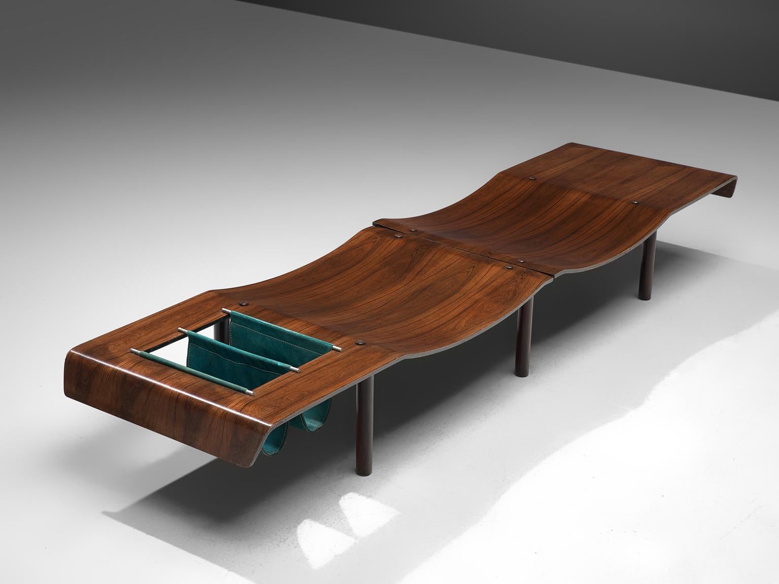Brazilian rosewood bench, metal en leather, Brazil, 1959-1969.

This Brazilian rosewood bench features molded and curved seats, placed in a symmetrical, repeating way that results in an organic, aesthetic wave. The organic, warm toned wooden bench