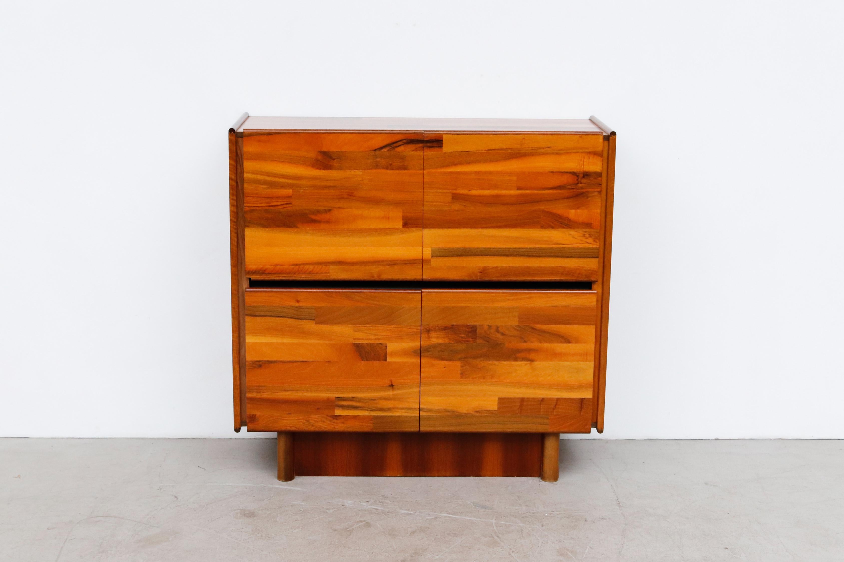 Jorge Zalszupin style patchwork dry bar or cabinet with gloss finish. One drop down bar door and side cabinet with lower double door storage. In original condition with some scratching and wear consistent with its age and use. Larger matching