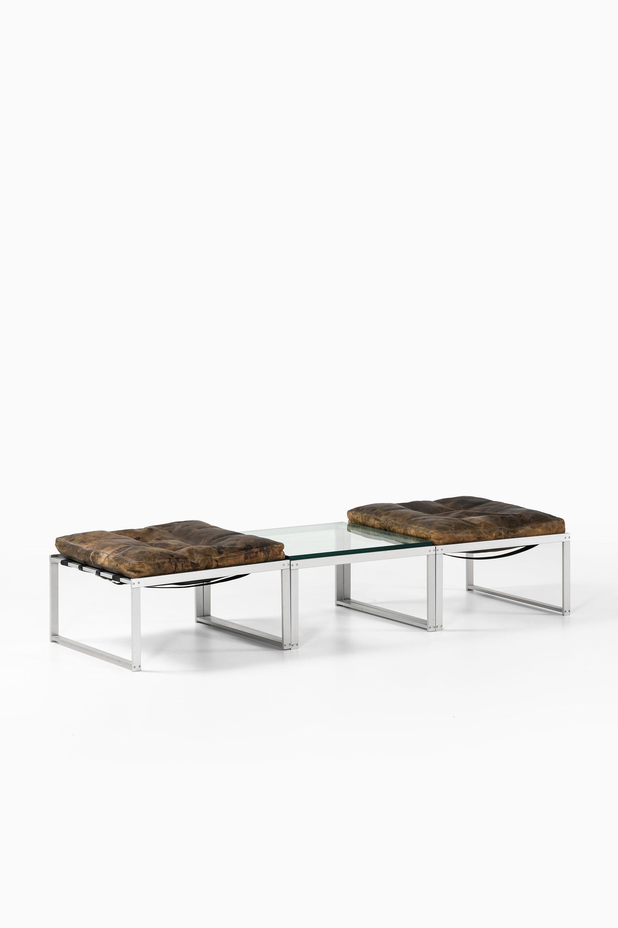 Set of 2 Stools & Side Table in Aluminium, Glass with Leather by Jørgen Højs, 1960's

Additional Information:
Material: Aluminium, glass and leather
Style: Mid century, Scandinavian
Produced by Niels Vitsøe in Denmark
Dimensions (W x D x H): 60 x 60