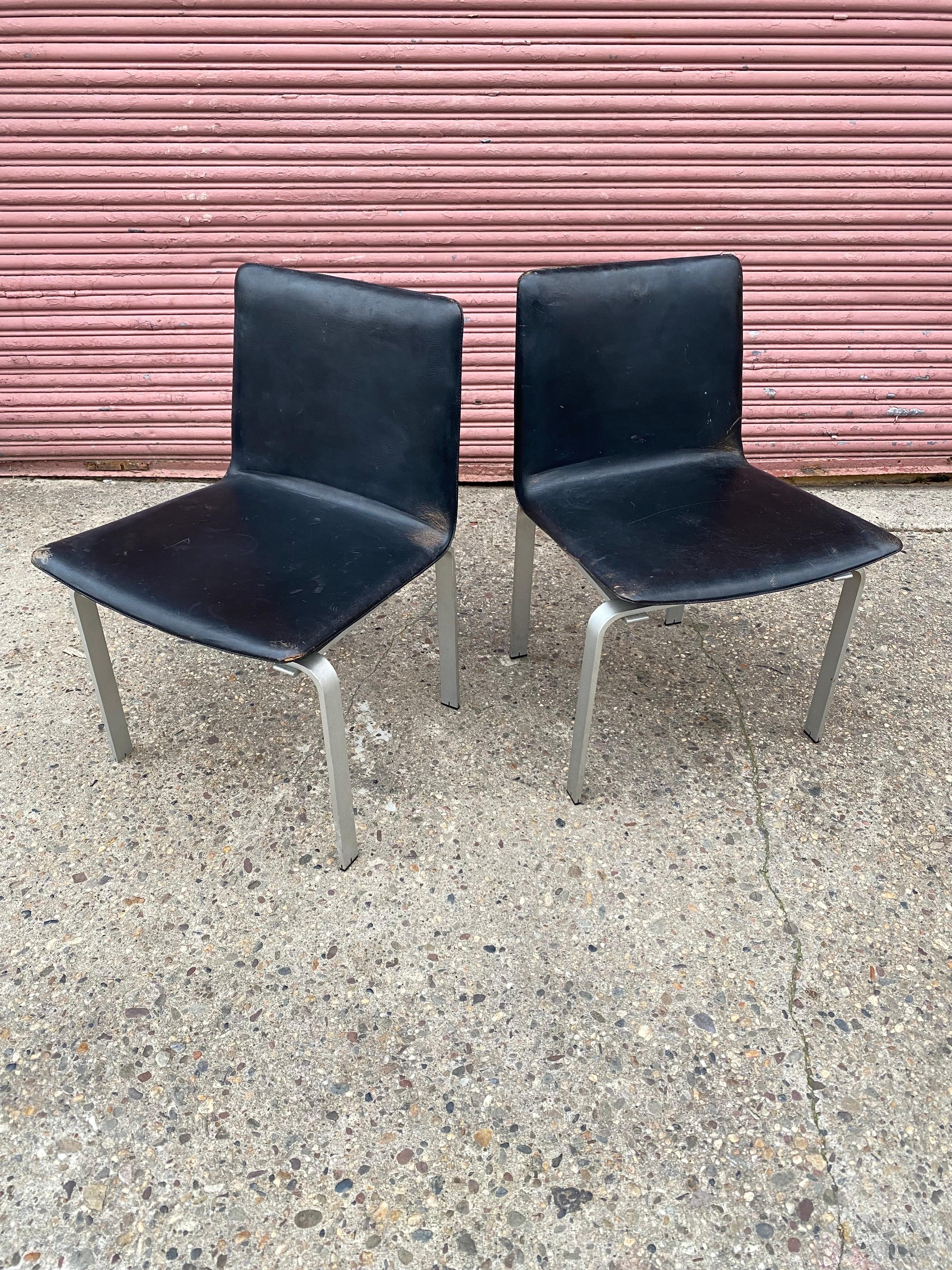 Jorgen Hoj Pair of elegant and handsome Aluminum and leather Chairs.  Hoj was a student of Poul Kjaerholm and the influence is clear.  Beautifully made.  This pair shows wear and tear!  Edge wear to leather and one plastic foot is missing!  See