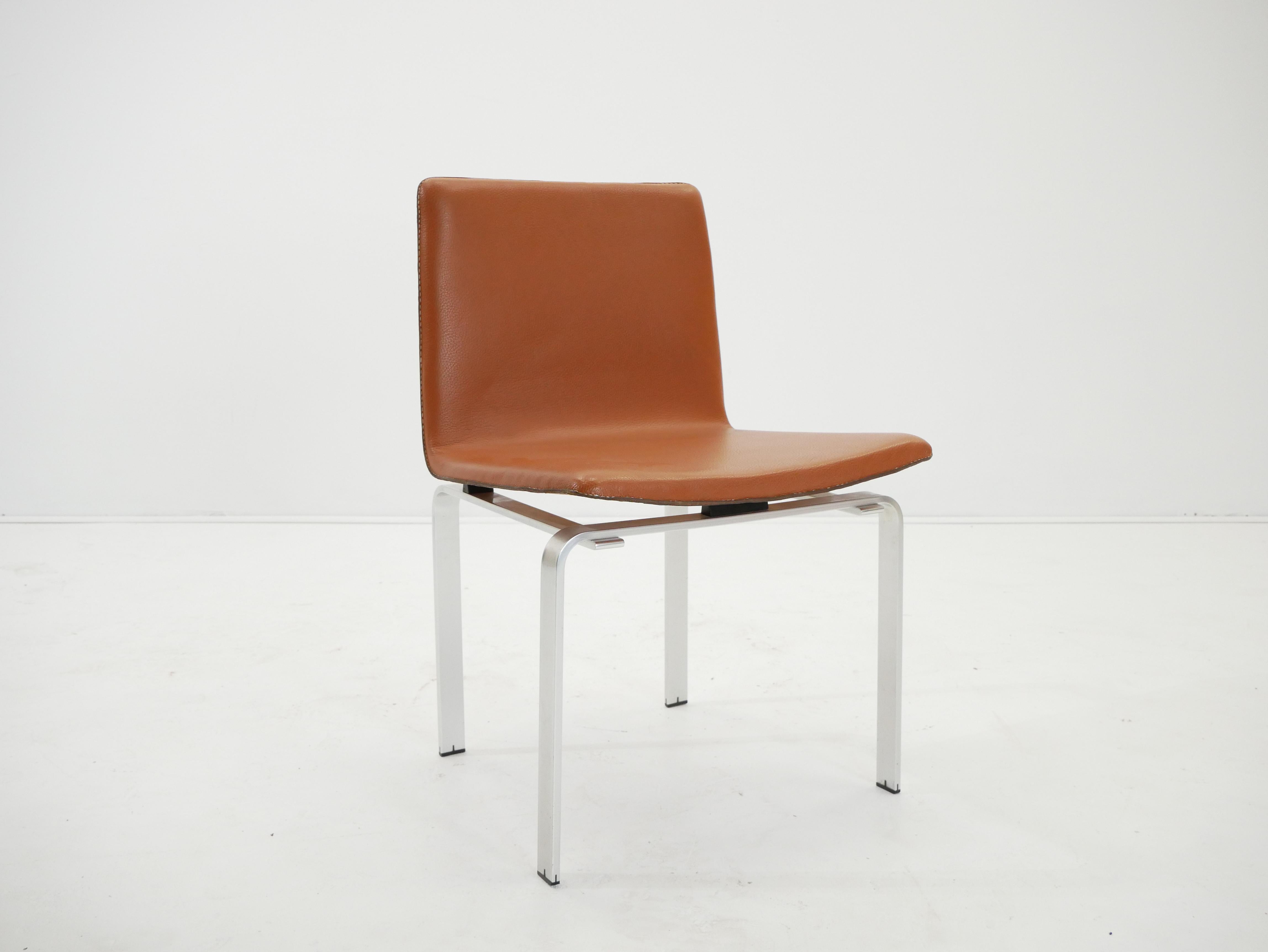 Jorgen Hoj for Niels Vitsoe chair in brushed aluminum and orange Leather, designed in Denmark c. 1962.
