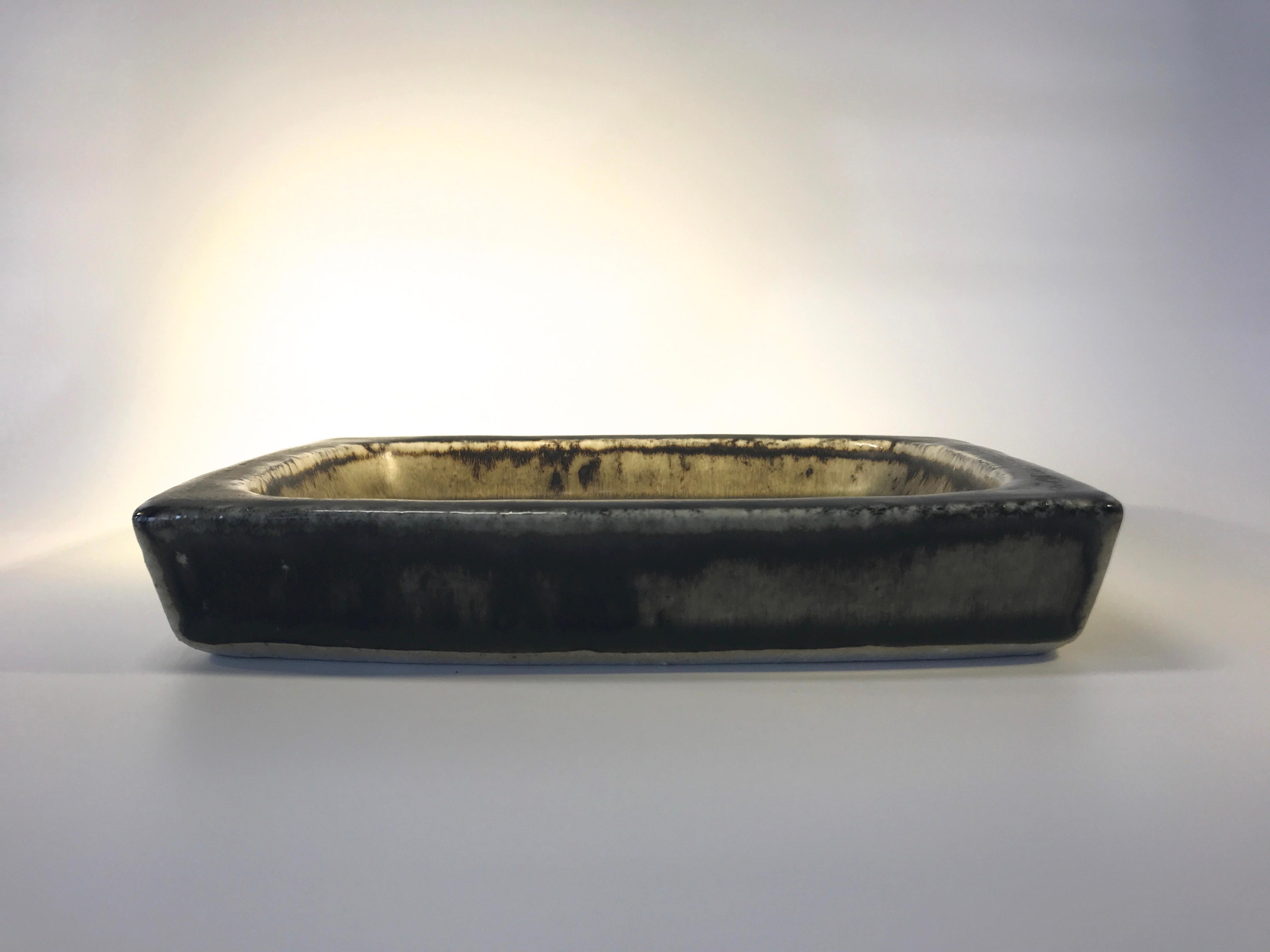 Oblong stoneware Scarab dish by Jorgen Mogensen for Royal Copenhagen, 1969.
The darkest of brown glazes with a dark blue and sand intriguing design of scarab beetles
Length 8.25 inch, Width 6 inch, Depth 1.5 inch
Excellent condition and glaze
Wear