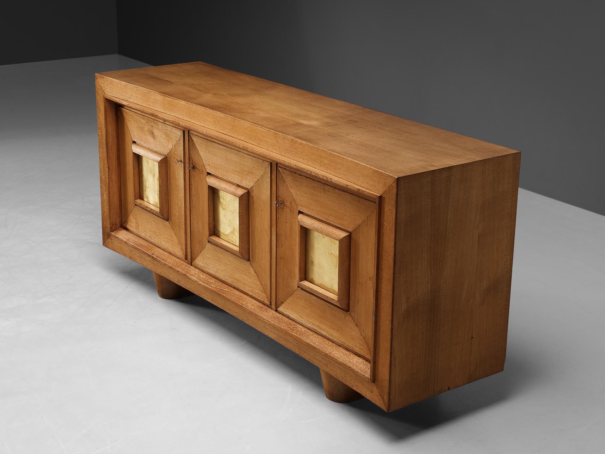 Jorj Rual, sideboard, oak, gold leaf, France, 1930s.

This utterly well-balanced sideboard is characterized by a rectangular shape, featuring strong vertical and horizontal lines and provides plenty of storage space. The design is executed in