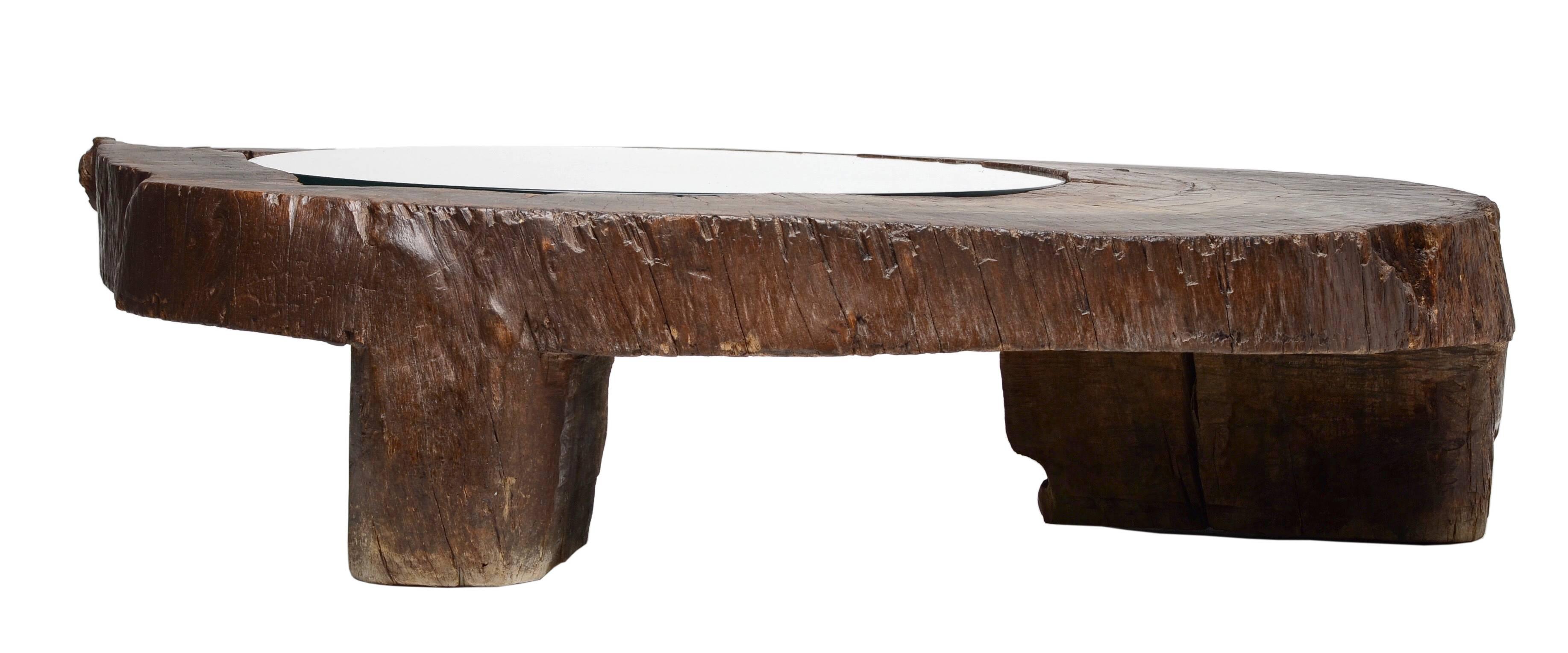 A very rare and exceptional coffee table by Zanine Caldas, circa 1970. 

This example in a solid mahogany trunk base with off-circular glass top. 
An incredible piece with great form and scale. A monumental example from the Brazilian Master.