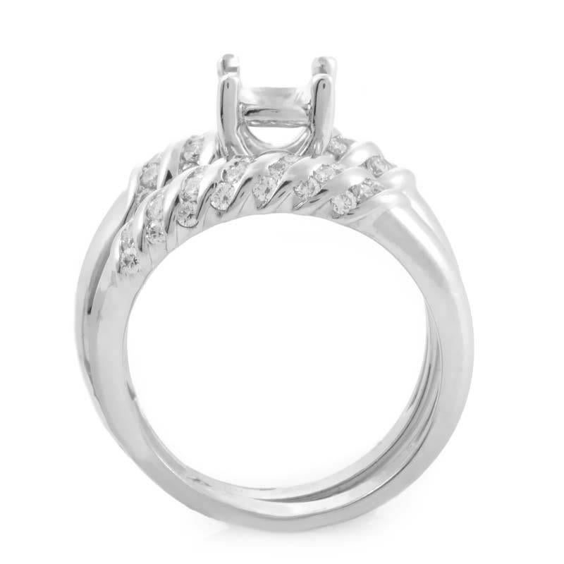 This engagement set from Jose Hess is absolutely stunning and is quite unique in design. The set features a wedding band and an engagement ring mounting made of 18K white gold and are set with glittering white diamonds.
