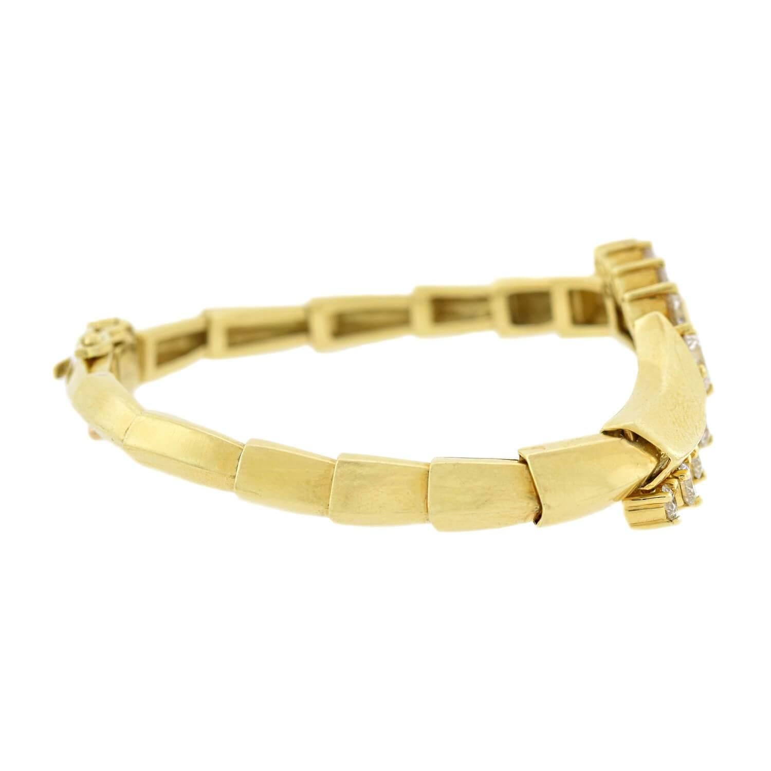 A fabulous contemporary diamond bracelet by acclaimed jewelry designer Jose Hess! Crafted in vibrant 18kt yellow gold, this bracelet stars nine sparkling Modern Brilliant Cut diamonds which curve along the front of a bypass-style design.