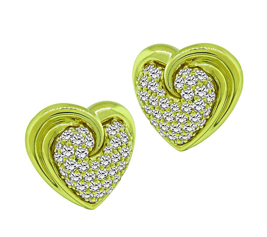 This is a beautiful pair of 18k yellow gold heart earrings by Jose Hess. The earrings feature sparkling round cut diamonds that weigh approximately 4.50ct. The color of these diamonds is E-F with VVS clarity. The earrings measure 21mm by 22mm and