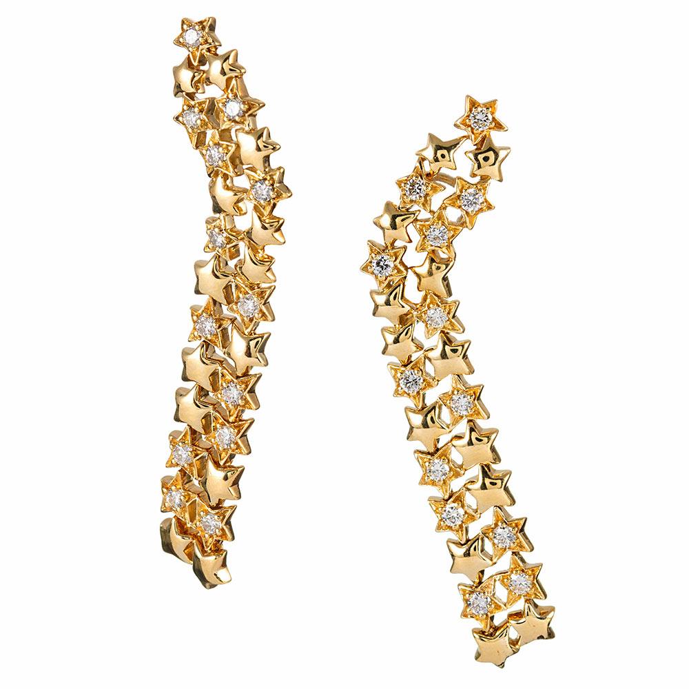 Cascades of golden stars intermittently set with diamonds offer lovely movement as they sway to and fro. These earrings are glamourous and fun! They are made of 18 karat yellow gold and set with 1.30 carats of brilliant white diamonds. Signed Jose