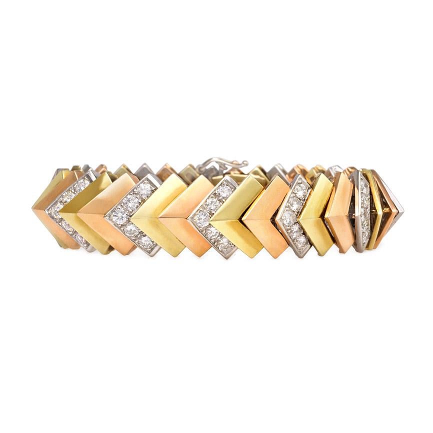 A three-color gold and diamond bracelet of chevron shaped links, in 14kt.  Jose Hess.  Atw 9.00 cts.