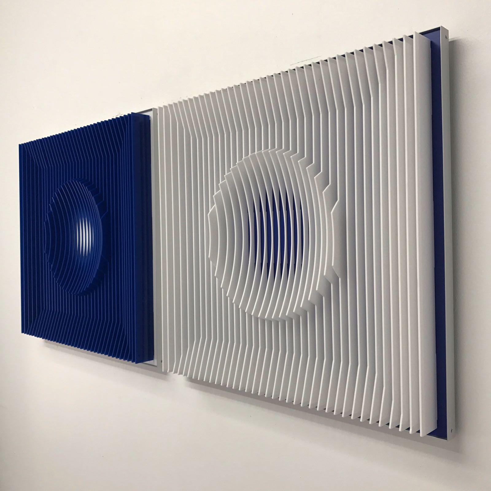 This beautiful diptych by Margulis is a contemporary kinetic wall sculpture that can be hung horizontally or vertically. 
Please take a look at the video so how it looks from different angles
This diptych is also available in different colors,