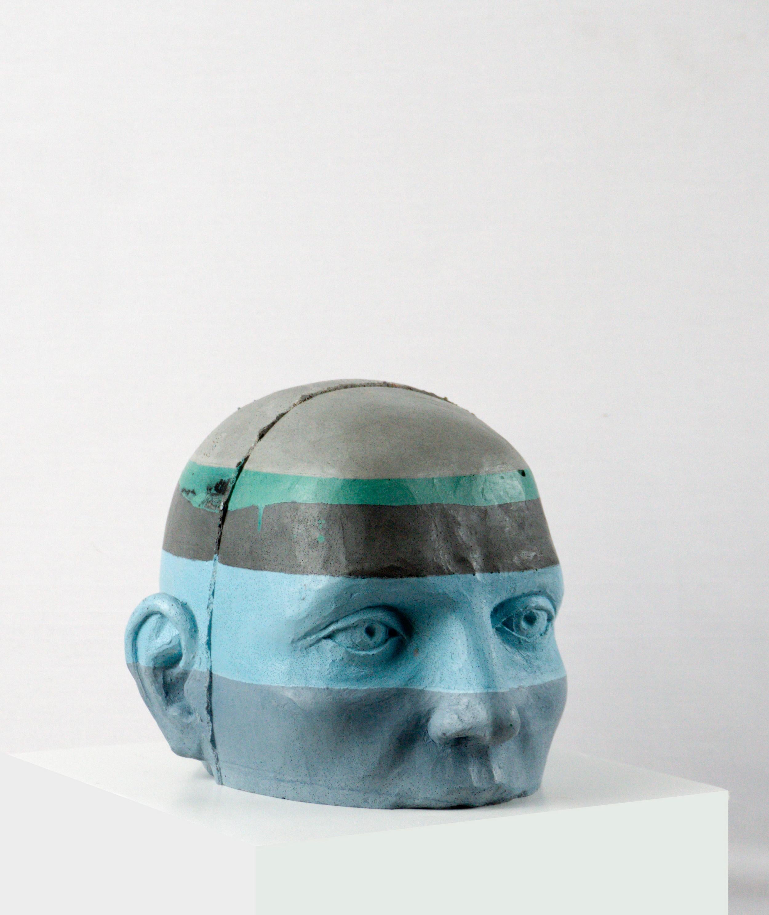 This architectural painted cement head sculpture introduces a layered chromatic vocabulary into the Proyectos subseries. In Project 20, the head is wrapped in alternating bands of blue, gray and teal tones, transforming the structural logic of