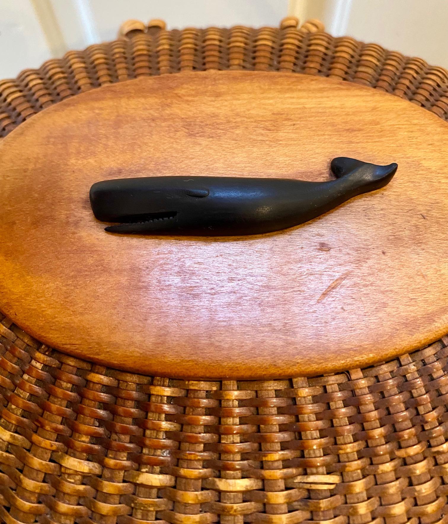 Very early vintage Nantucket Purse by Jose Formoso Reyes (1902 - 1980), Nantucket, circa 1950, an oval covered basket in the form of a woman's purse with cane staves and weave, shaped swing handle attached to rim by copper rivets, a carved ebony