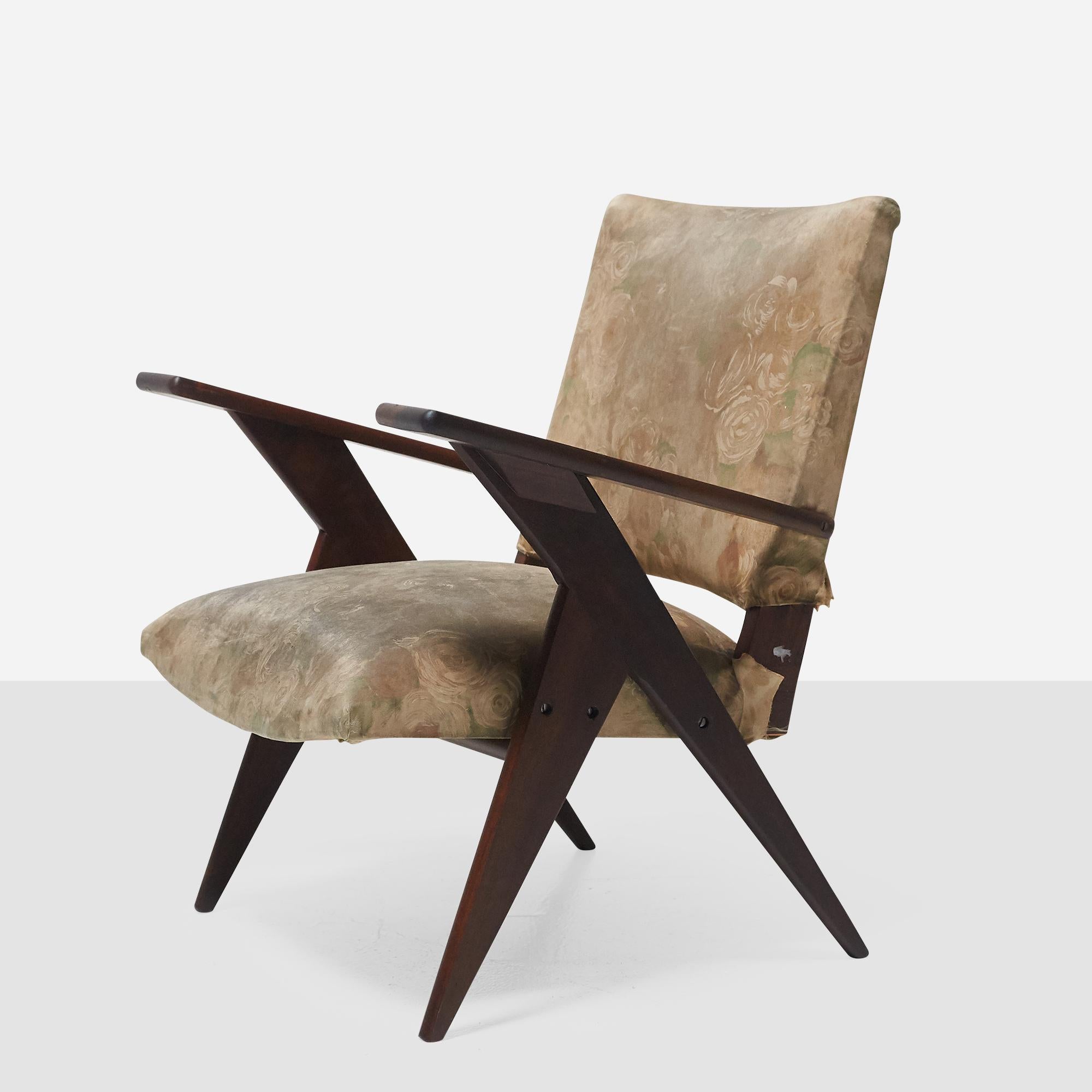 A Brazilian hardwood armchair by José Zanine Caldas with paddle arms and his signature angular lines.

The wood has been refinished and is in excellent condition. The upholstery is in original condition. This piece can be re-upholstered by our team