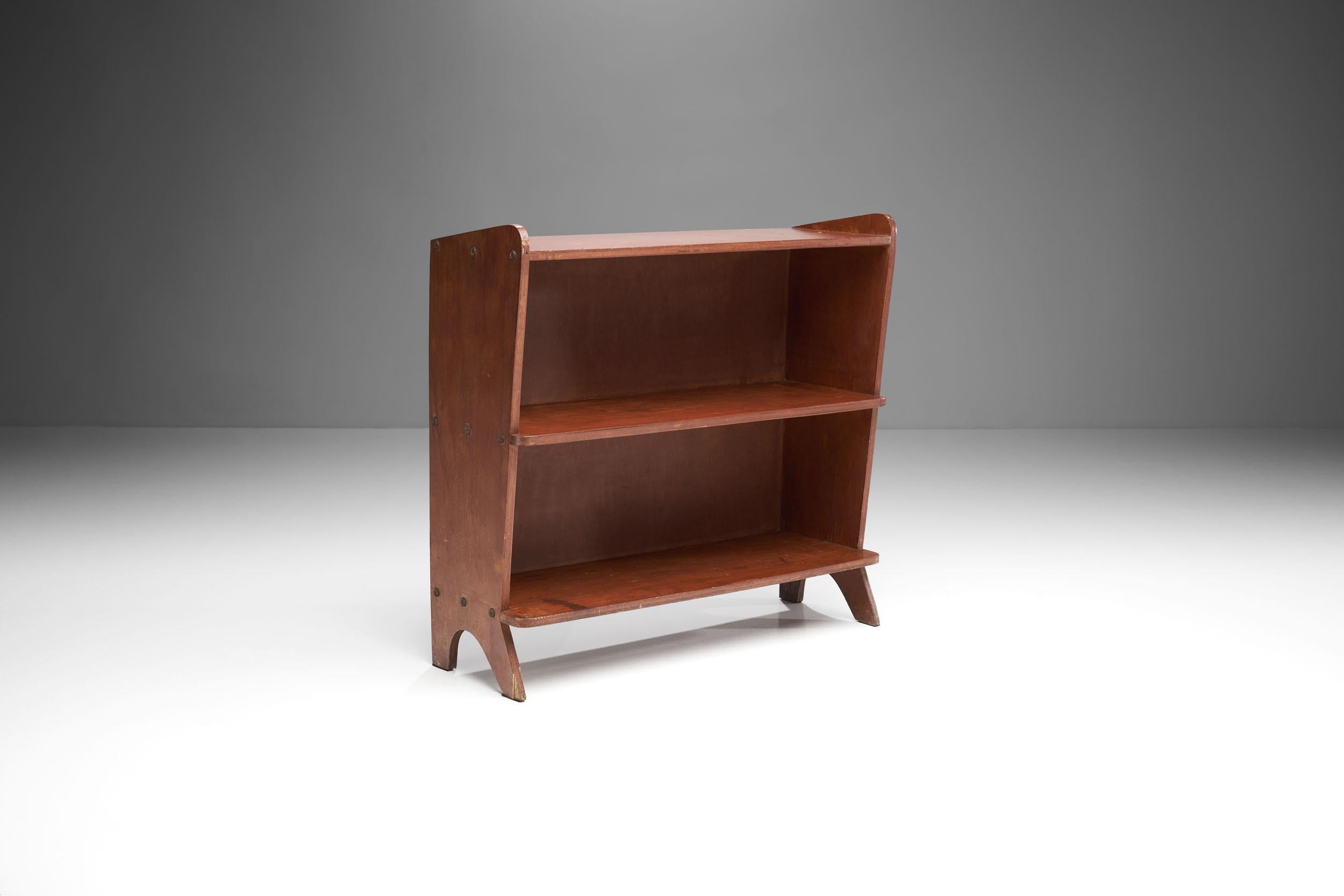 This bookcase is made out of thick plywood and features a sculptural and raw look that give it a lot of character. 

The sides have rounded out edges that are wider at the base and gradually become narrower towards the middle. The slightly raised