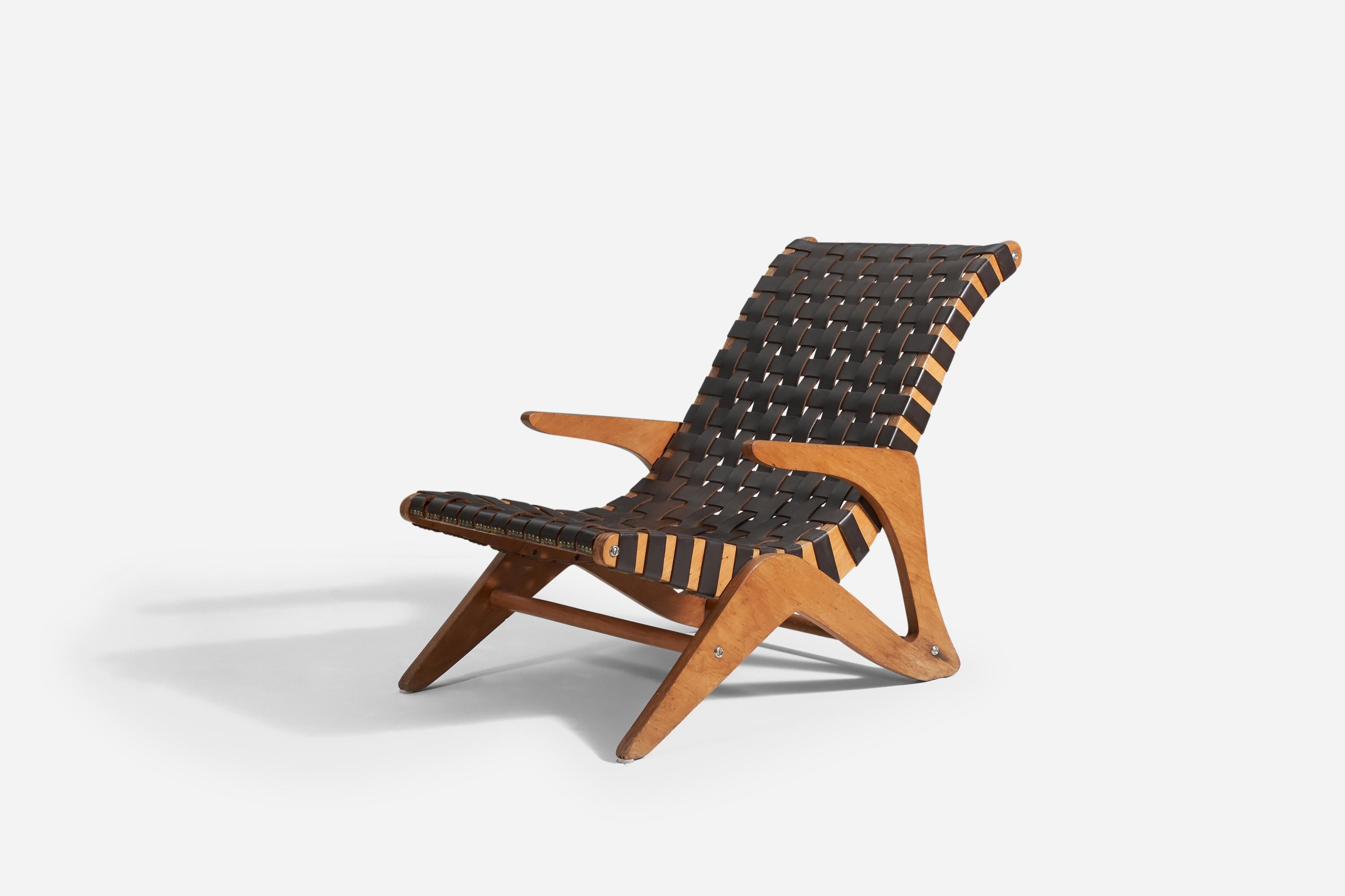 A lounge chair designed by José Zanine Caldas for Mòveis Artísticos Z, Brazil, in 1949. It features Imbuia plywood, brass, and black-dyed leather webbing.
 