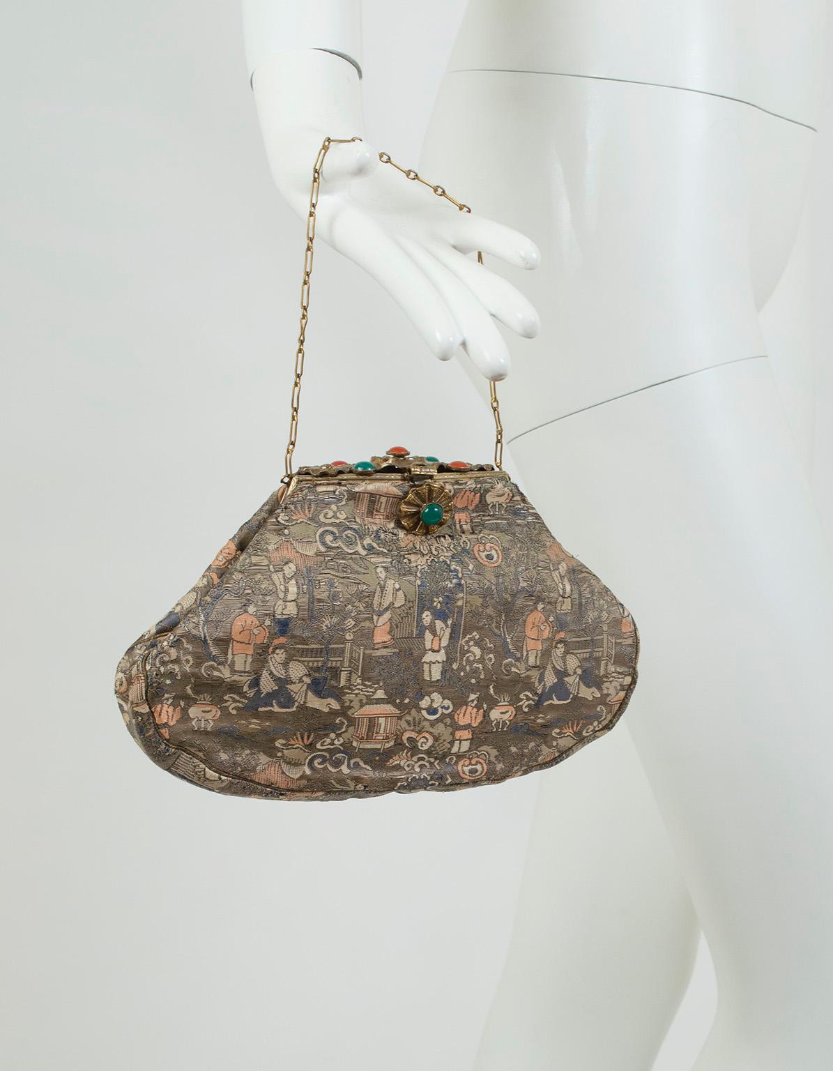 Subtly striking, this exquisite silk handbag features a muted Chinoiserie motif that would be remarkable on its own were it not upstaged by its unique figured brass top lid, which is worked to resemble rigid flowers with coral and emerald cabochons