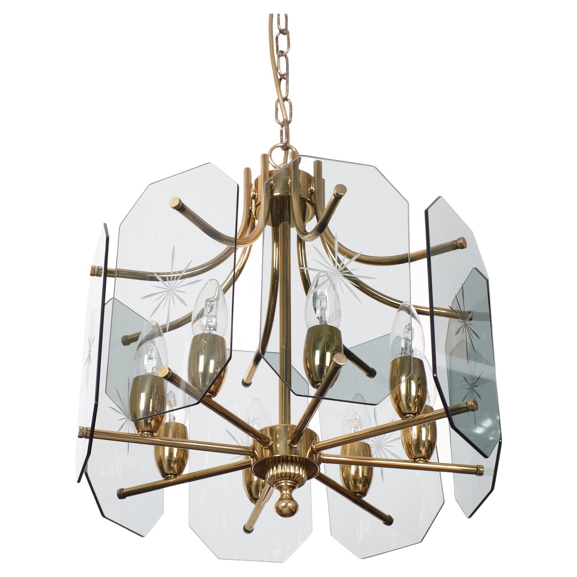 Beautiful chandelier. Brass and cut Glass plates. Design by Josef Brumberg Beleuchtungskörperfabrik 1970s Germany. Sundern. Hollywood Regency style. 
8 small socket bulbs needed. Very good condition.