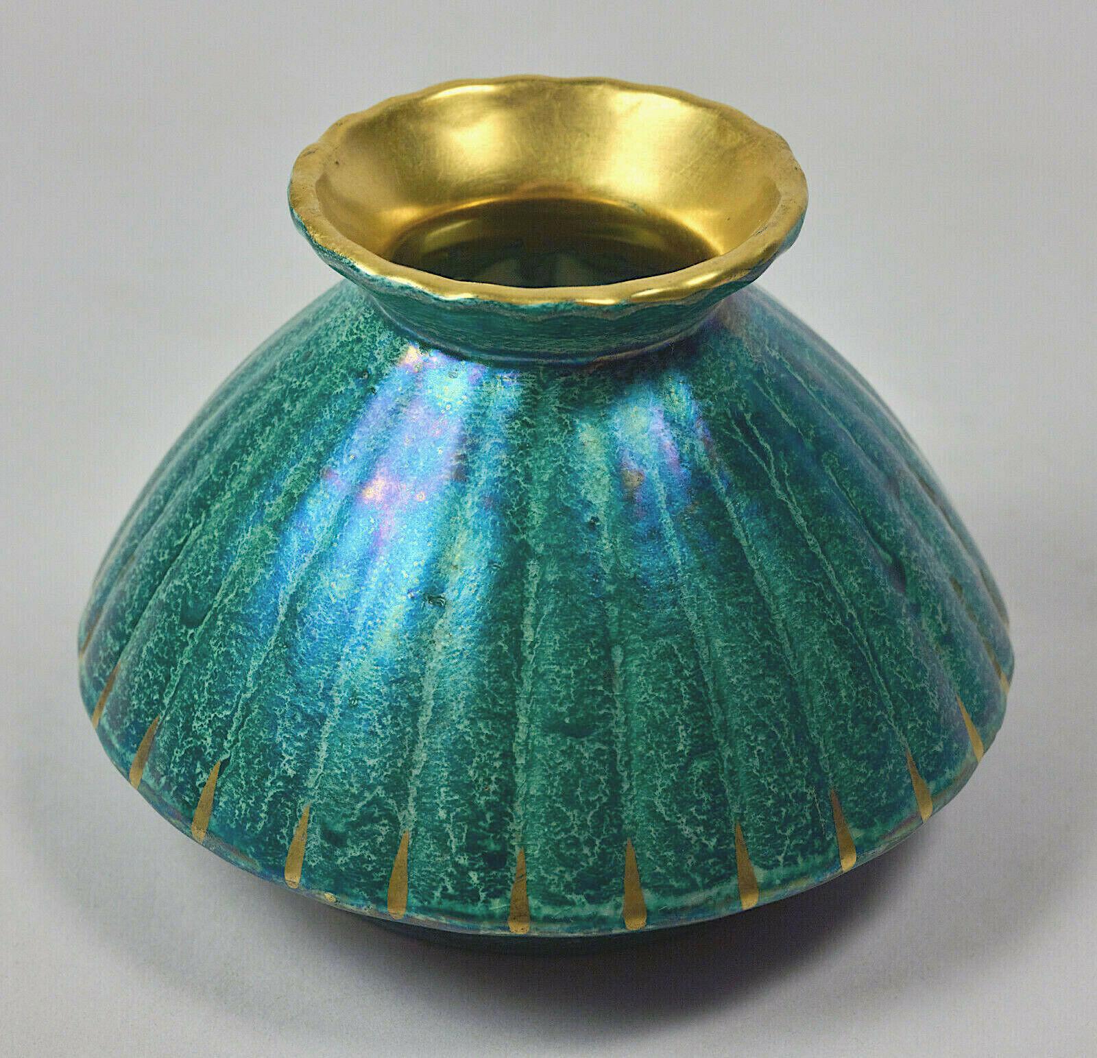 A Josef Ekberg (1877-1945) Scandinavian Art Deco cabinet vase from the Gustavsberg Porcelain Factory of Sweden, produced during the second quarter of the 20th century. The ribbed vase is decorated with a striking iridescent luster glaze of marbled
