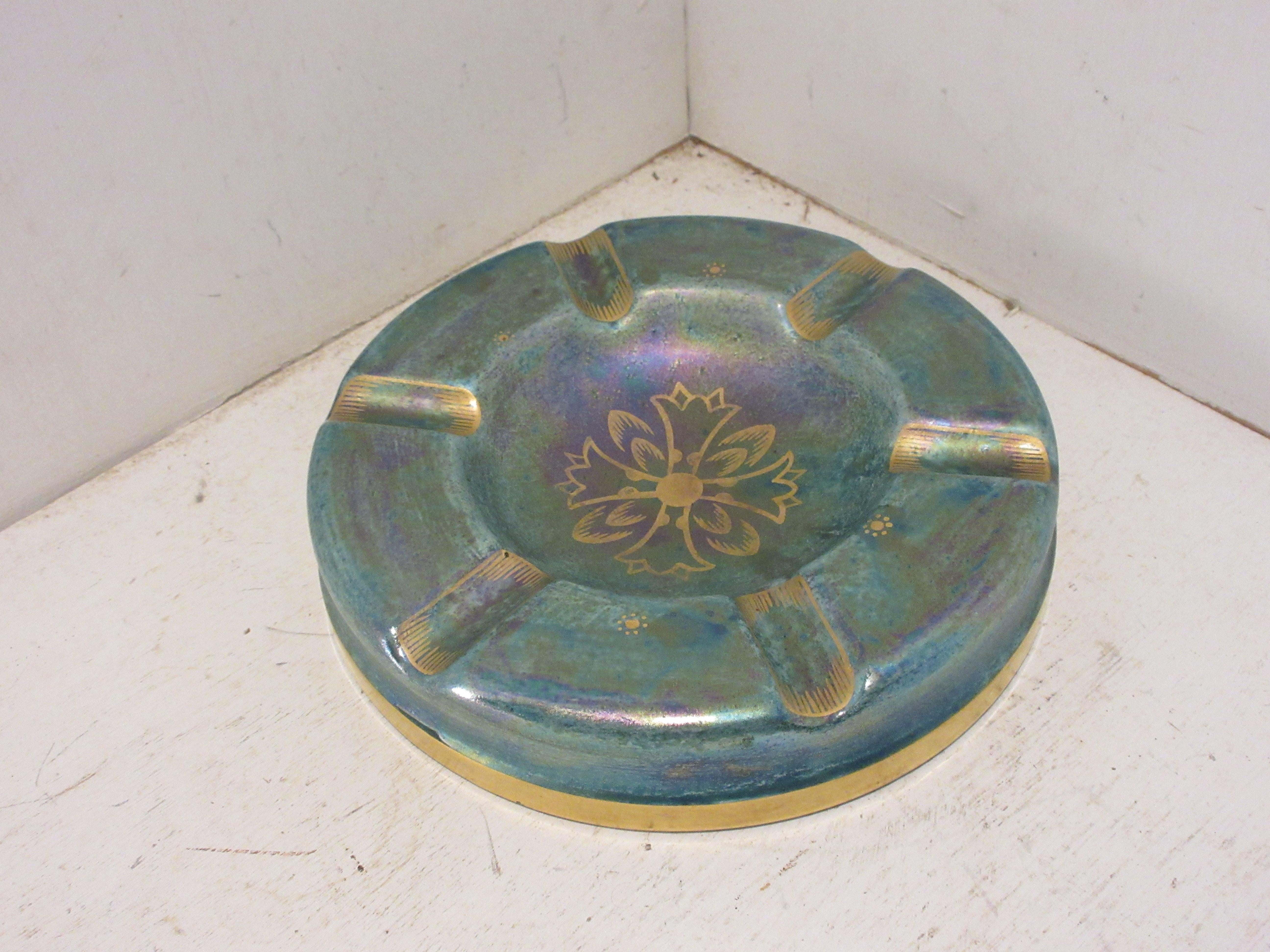 This is a handmade rare Swedish Art Deco ceramic ashtray in green and gold luster glaze hand decorated with gold made by the Swedish ceramic artist Josef Ekberg . He was one of Sweden`s Top Ceramic artist at the time. He started working at the