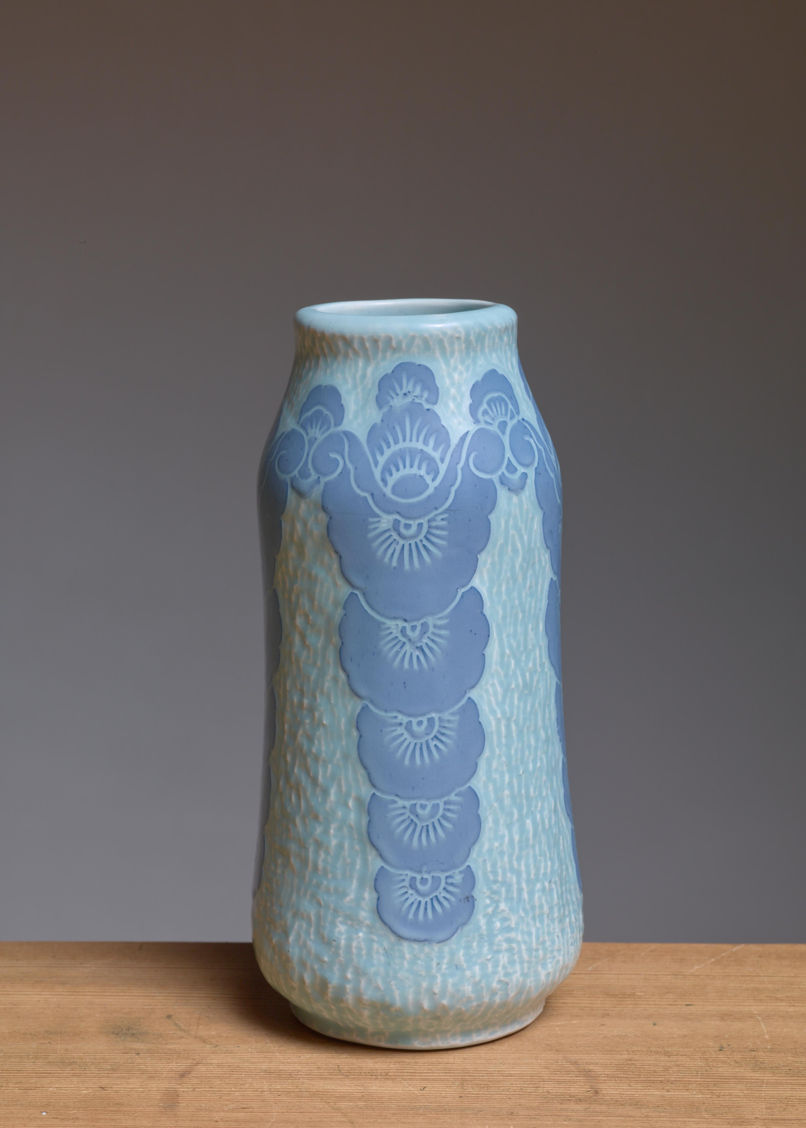 A ceramic vase by Swedish artist Josef Ekberg (1877-1945) for Gustavsberg. The vase has a blue glaze finish with a Sgraffito flower motif.