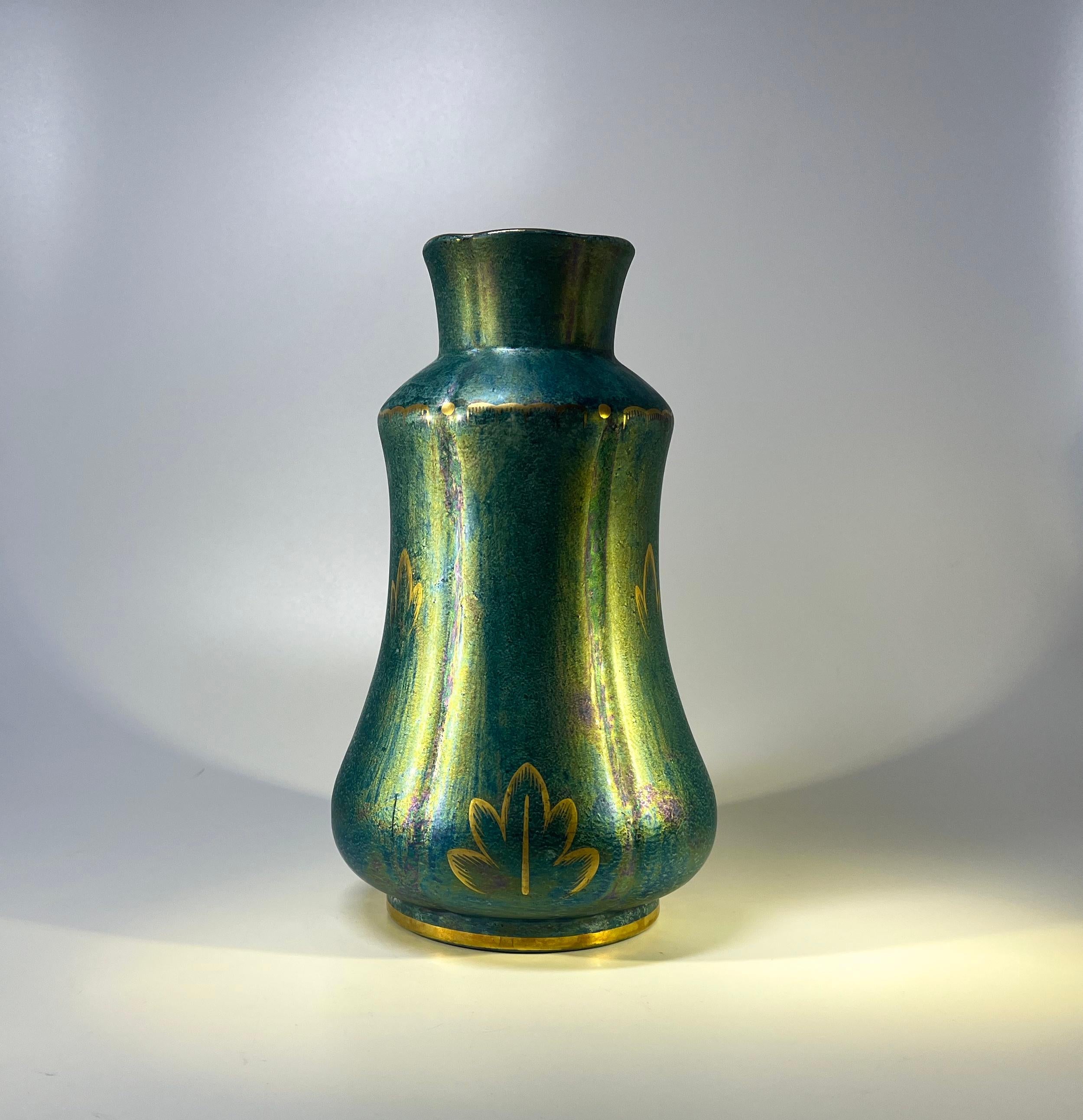 Sea green ethereal lustre glaze with hand decorated gilt motifs decorate this superb vase by Josef Ekberg for Gustavsberg. 
An extremely impressive Art Deco piece and a fine example of Ekberg's craftsmanship.
Signed and Anchor mark to