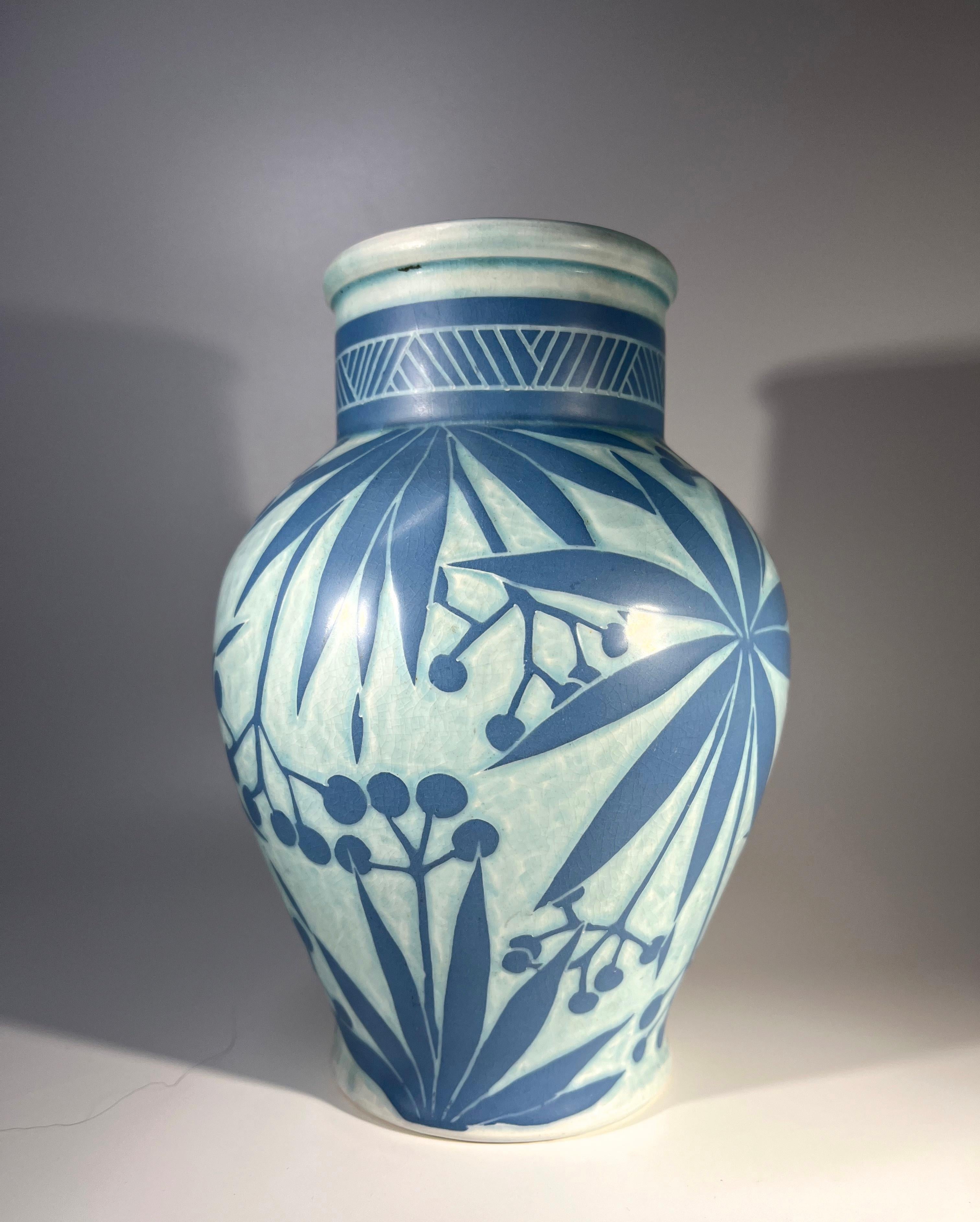 Striking Art Deco sgraffito ceramic vase by Josef Ekberg for Gustavsberg. 
Layers consist of pale blue ground and mid blue palm leaf decoration
Signed Ekberg and dated 1911 
Height 8 inch, Width 5.5 inch
A unique example of Ekberg's craftsmanship
In