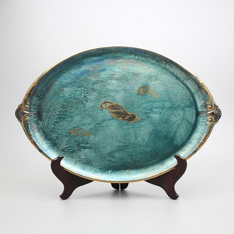 Josef Ekberg (1877 -1945) for Gustavsberg, Sweden
Large oval platter in ceramic. Blue-green glaze with gold decoration. 
Measures 46 x 31 cm. 
In good condition.