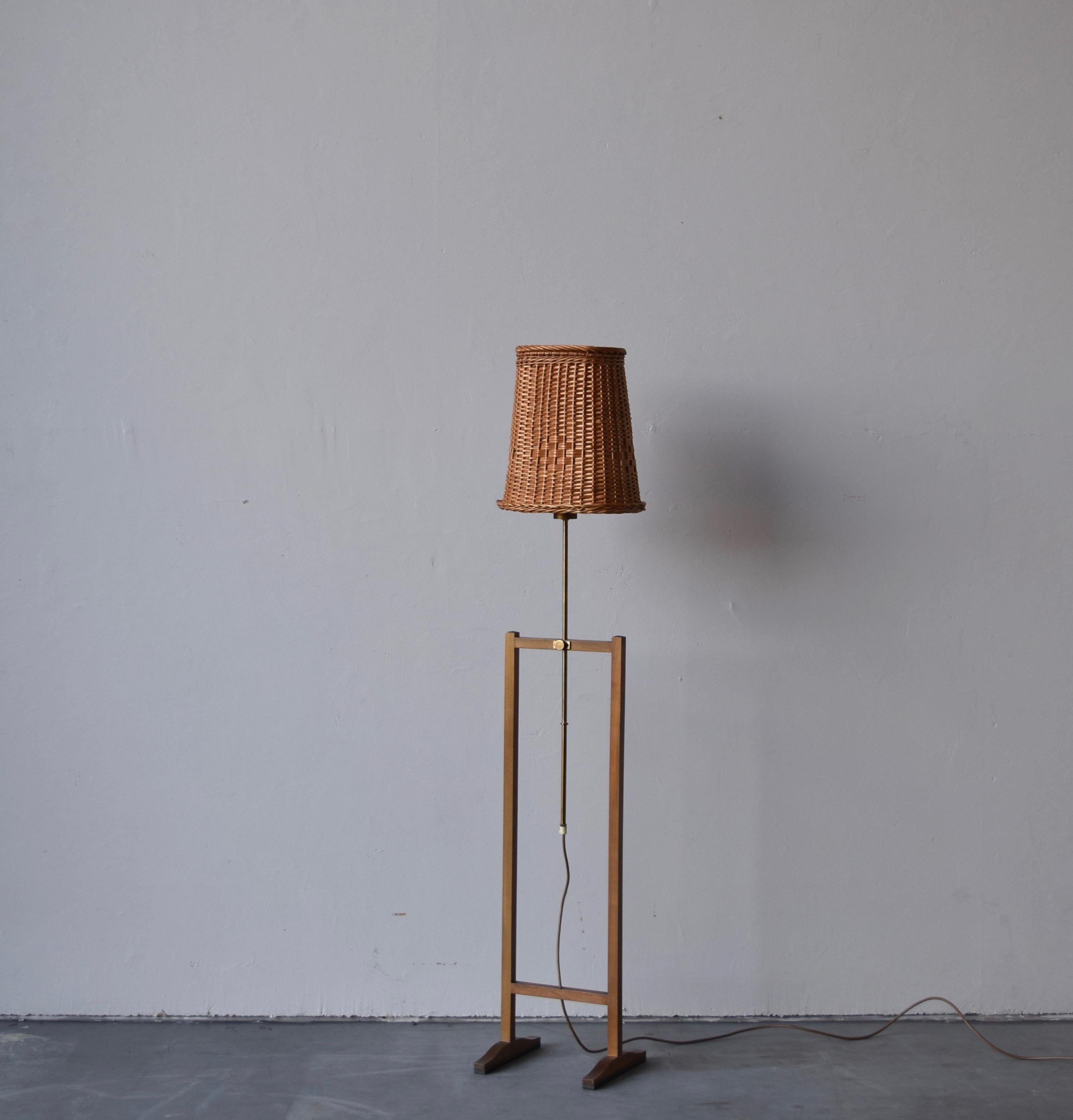 An early production adjustable floor lamp. Designed by Austrian architect Josef Frank for Swedish firm Svenskt Tenn, Stockholm. 

In brass, mahogany, and with assorted vintage rattan lampshade.

Other designers of the period include Paavo