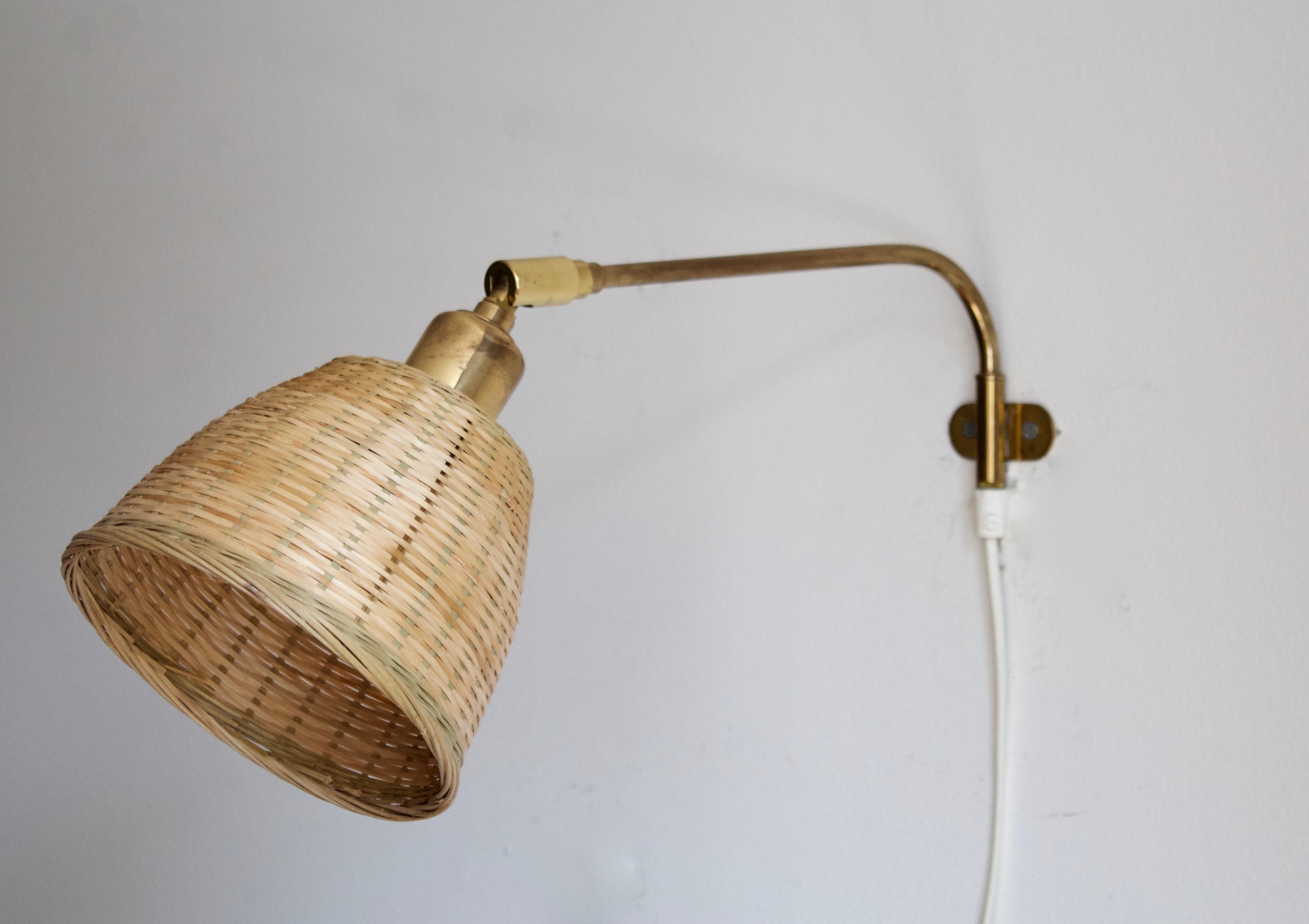 An adjustable wall light / sconce / task light. Designed by Josef Frank, produced by Svenskt Tenn, Stockholm, Sweden, c. 1950s. 

Stated dimensions include lampshade as is illustrated. Assorted vintage rattan lampshade.

Other designers of the