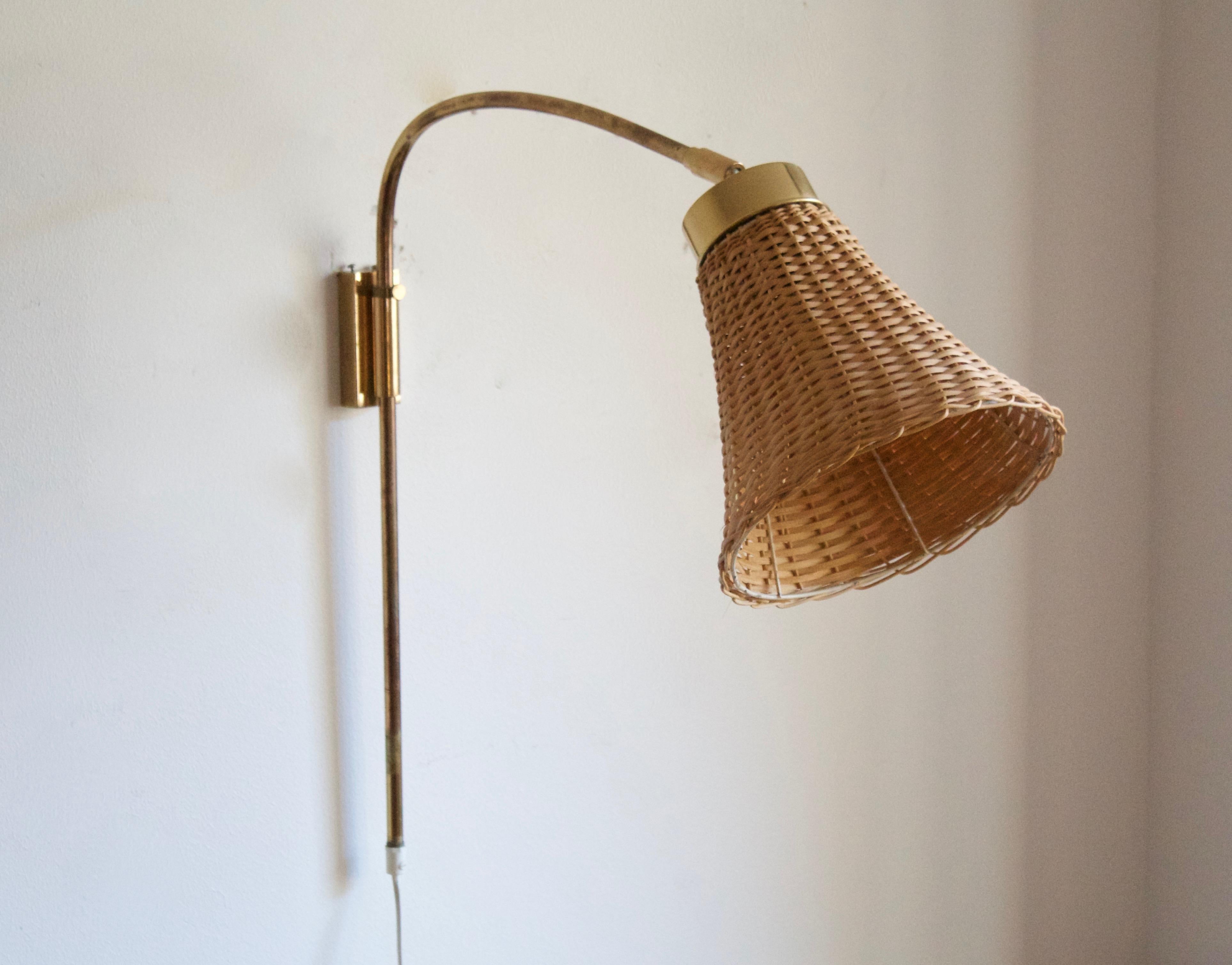 An adjustable wall light / sconce / task light. Designed by Josef Frank 1920s, produced by Svenskt Tenn, Stockholm, Sweden, c. 1950s. 

Stated dimensions include lampshade as is illustrated. Assorted vintage rattan lampshade.

Other designers of