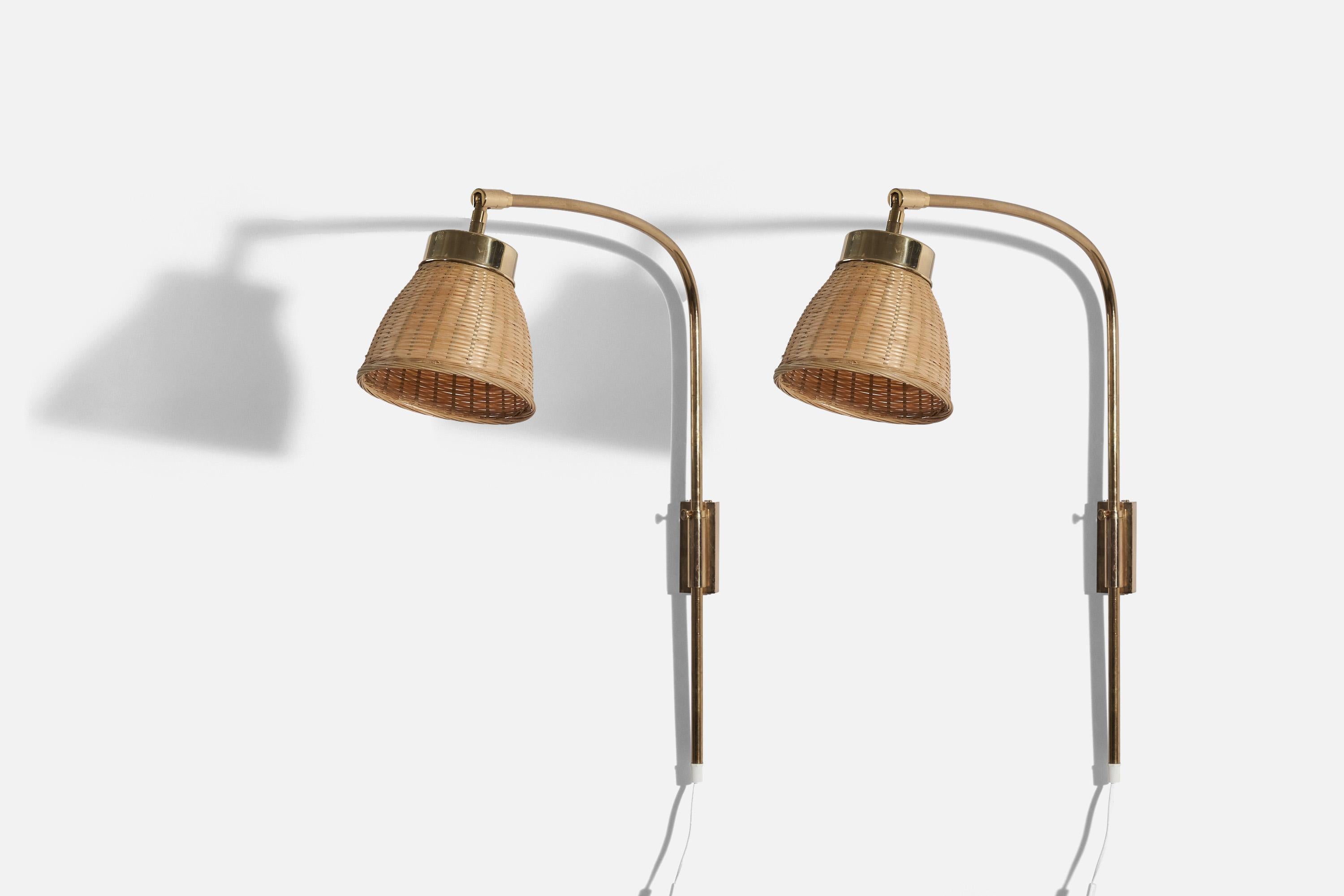 A pair of adjustable, brass and rattan wall lights, designed by Josef Frank and produced by Svenskt Tenn, Stockholm, Sweden, c. 1950s. 

Variable dimensions, measured as illustrated in the first image. 

Dimensions of the back plate (inches) : 4