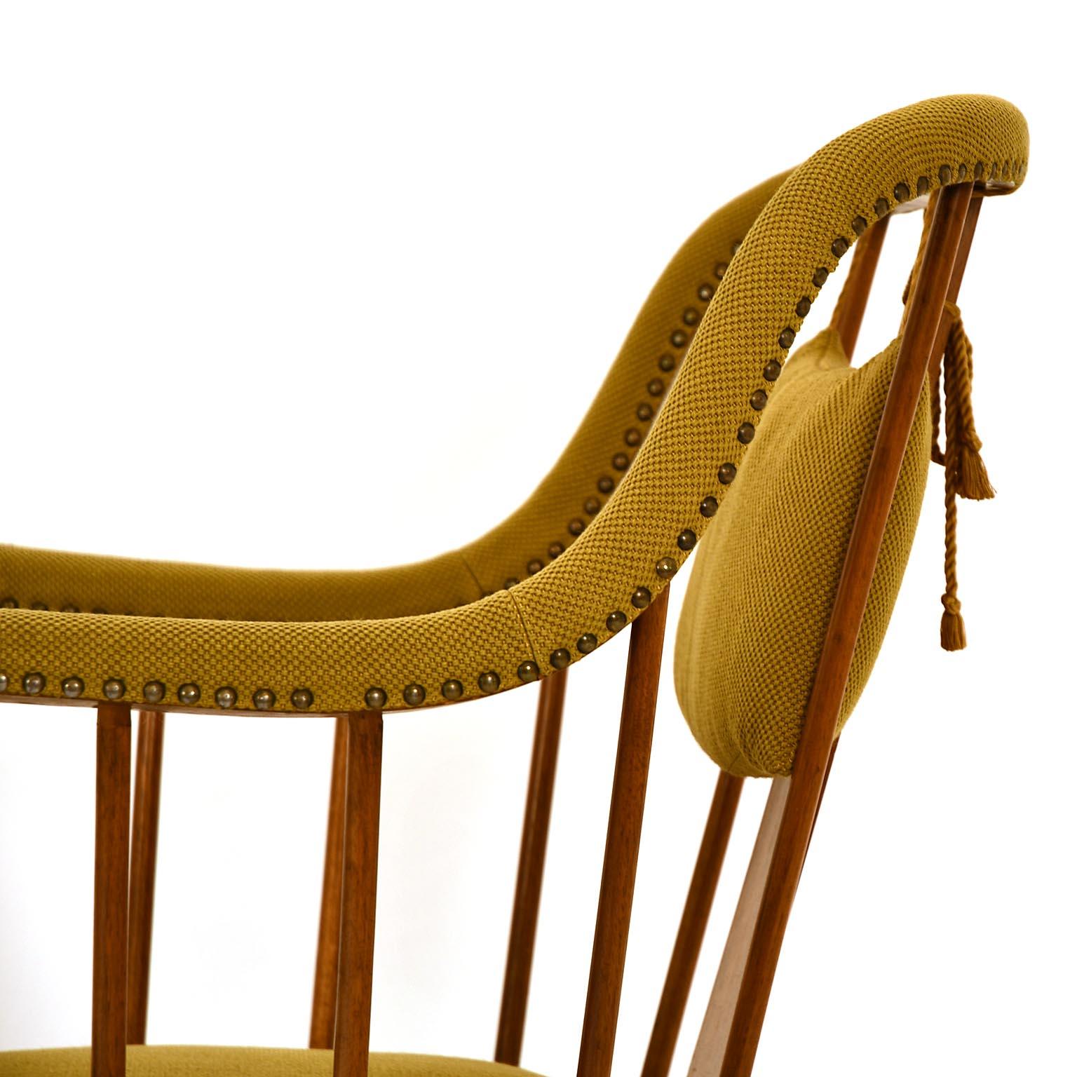 Josef Frank designed this chair circa 1925 in a smaller version and 1930 in a larger, more comfortable one. He used it for the villa beer in Vienna, but also for the flat blitz also. Solid walnut base, seat of beech, brass upholstery tacks. The