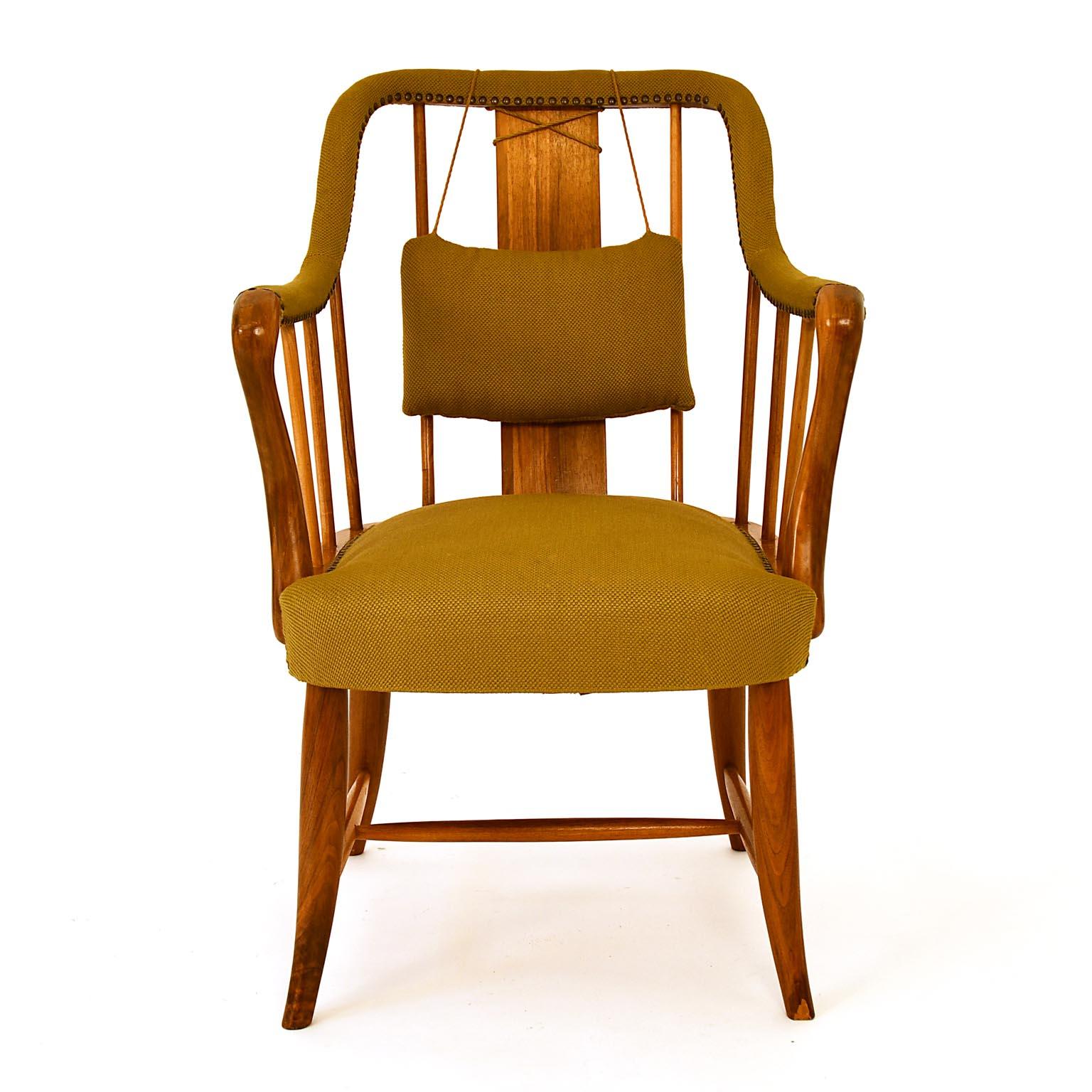 Josef Frank designed this chair circa 1925 in a smaller version and 1930 in a larger, more comfortable one. He used it for the Villa Beer in Vienna, but also for the flat Blitz also. Solid walnut base, seat of beech, brass upholstery tacks. The