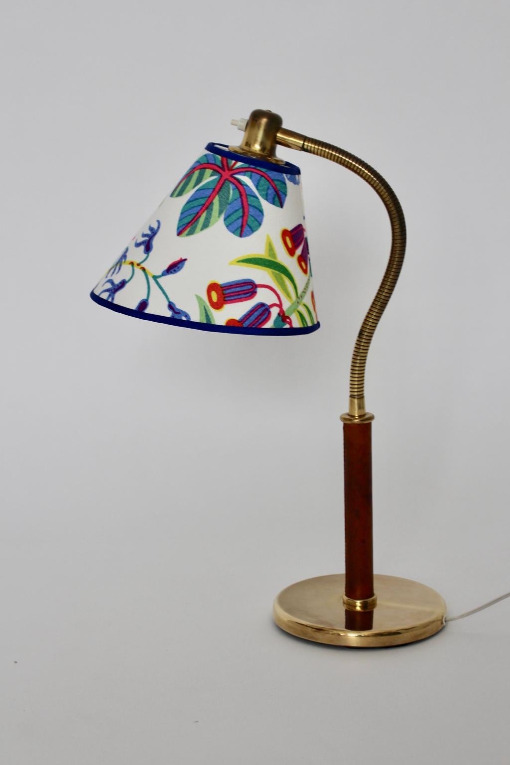 A table lamp by Josef Frank and executed by J. T. Kalmar Vienna, which has an adjustable flexible arm with a leather handle.
The renewed lampshade is covered with beautiful multicolored Josef Frank design textile fabric by Svenskt Tenn.
The table