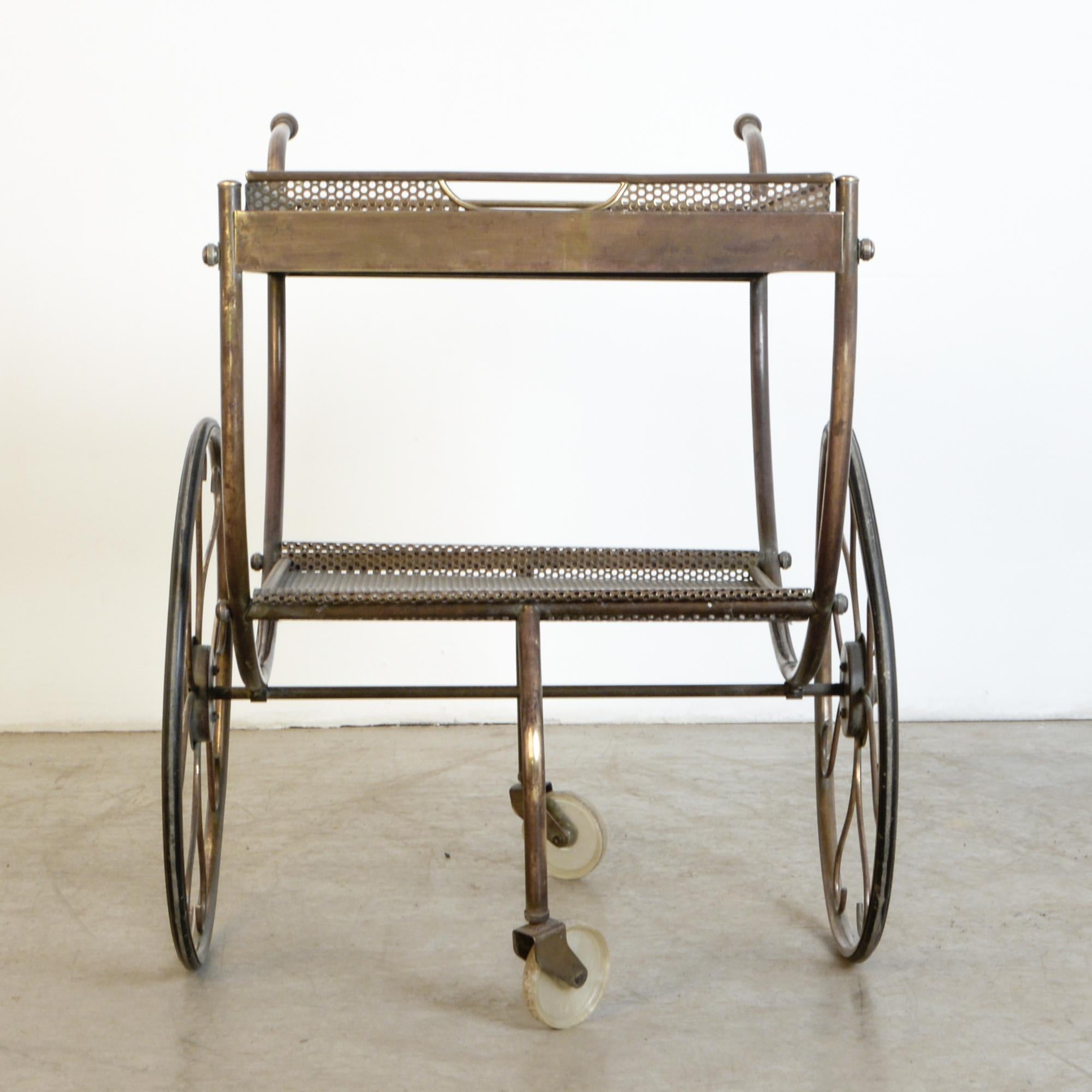 A great example of a classic design by Josef Svensk for Swedish furniture maker Svenskt Tenn from circa 1950. A beautiful decorative design with practical features, swivelling wheels, removable tray, and detailed construction. Great condition with a