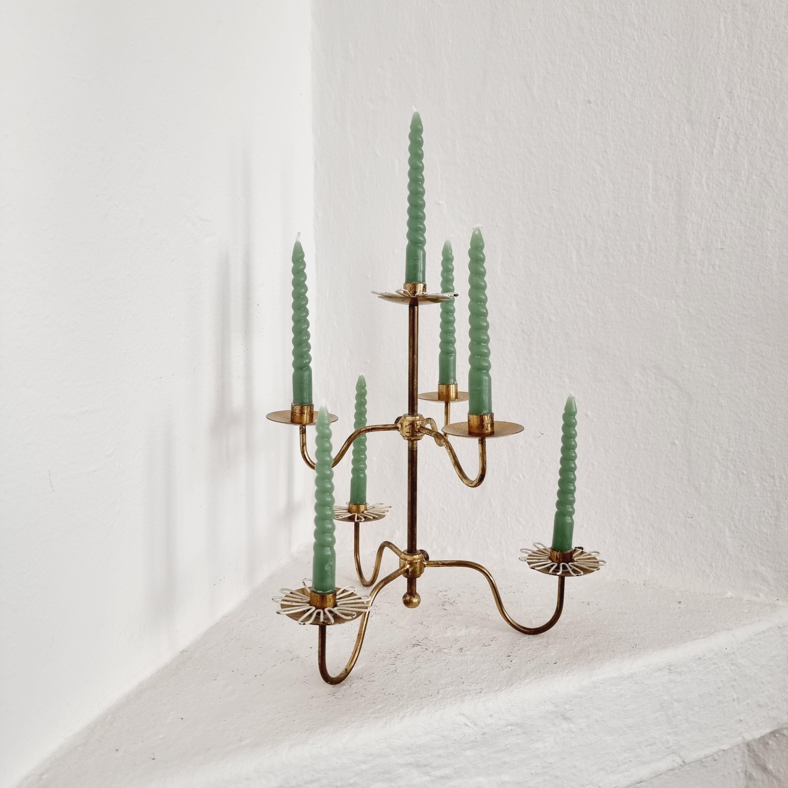 Candelabra / Candleholder in solid brass wit five rare candlerings in white colored metal. Attributed to Josef Frank for Firma Svenskt Tenn, mid-1900s / Swedish Modern.

Adjustable height. In good conditions, nice patina. Candlerings with signs of