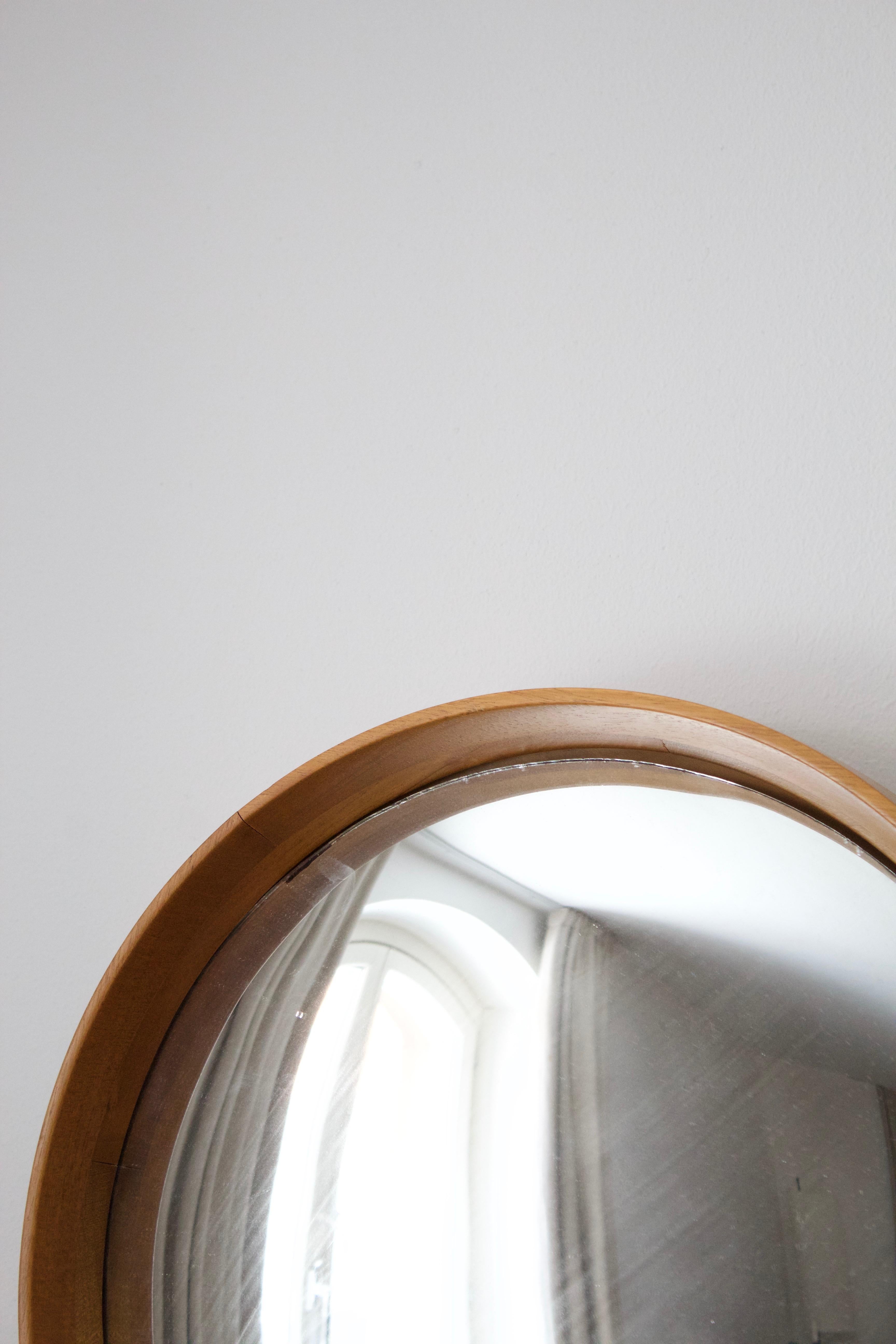 A wall mirror, designed by Josef Frank and produced by Svenskt Tenn, Sweden 1950s. 

Features a sculptural oak frame along. Thick convex mirror glass projects a wider field of view than a regular flat mirror.

  