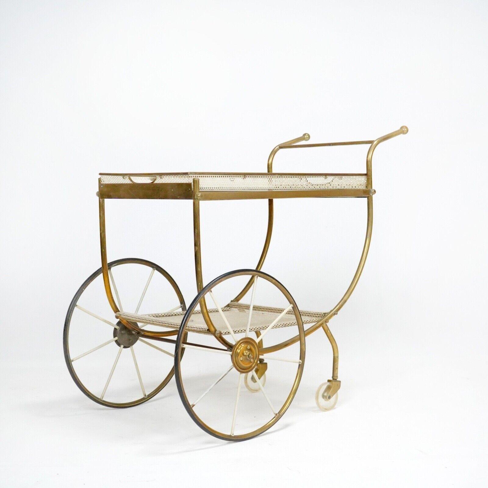 Serving trolley by Josef Frank for Svenskt Tenn, circa 1950.
Brass frame with perforated sheet metal shelf and removable tray. 
Wheels run smoothly.
 
Dimensions

H 75cm (handles) 63cm (top of tray)
W 43cm 
L 88cm (handle to wheel)
 
Condition