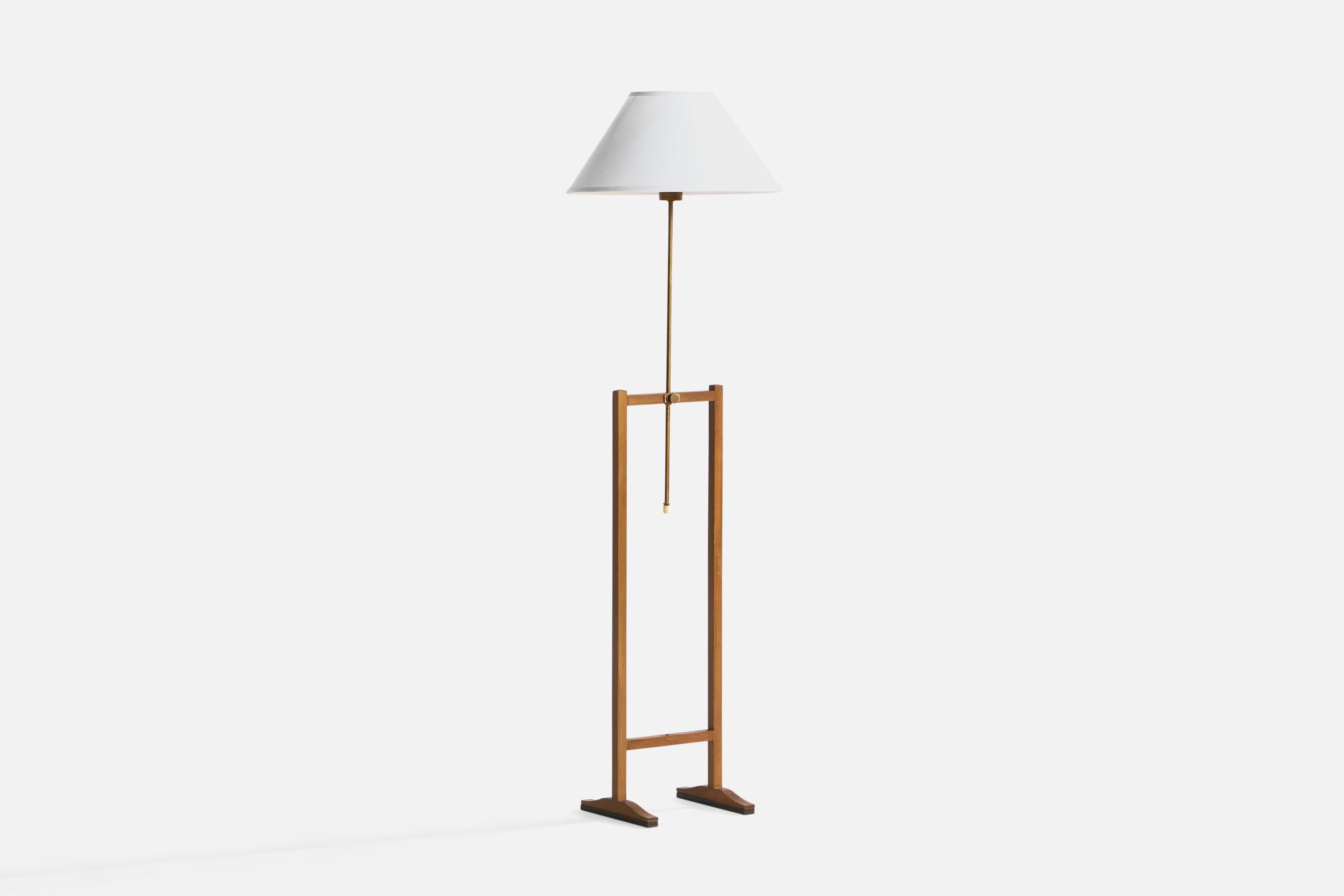 An adjustable brass, mahogany and white fabric floor lamp designed by Josef Frank and produced by Svenskt Tenn,, Sweden, 1940s.

Cord feeds from bottom of brass stem.

Overall Dimensions (inches): 54.38” H x 16.25” Diameter. Stated dimensions